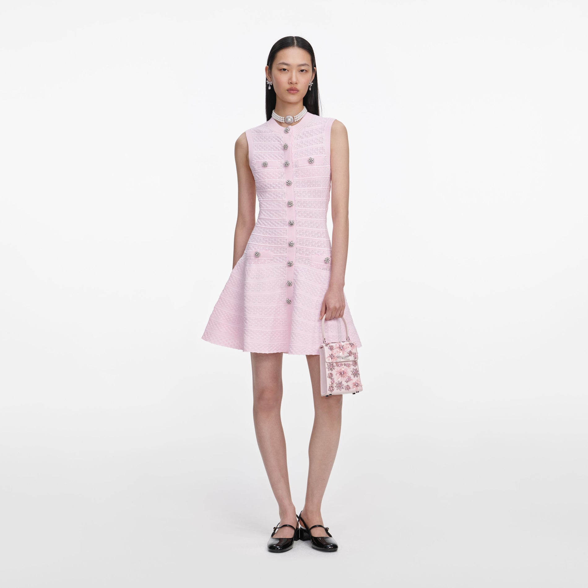 Front view of a woman wearing the Pink Pointelle Diamante Knit Mini Dress