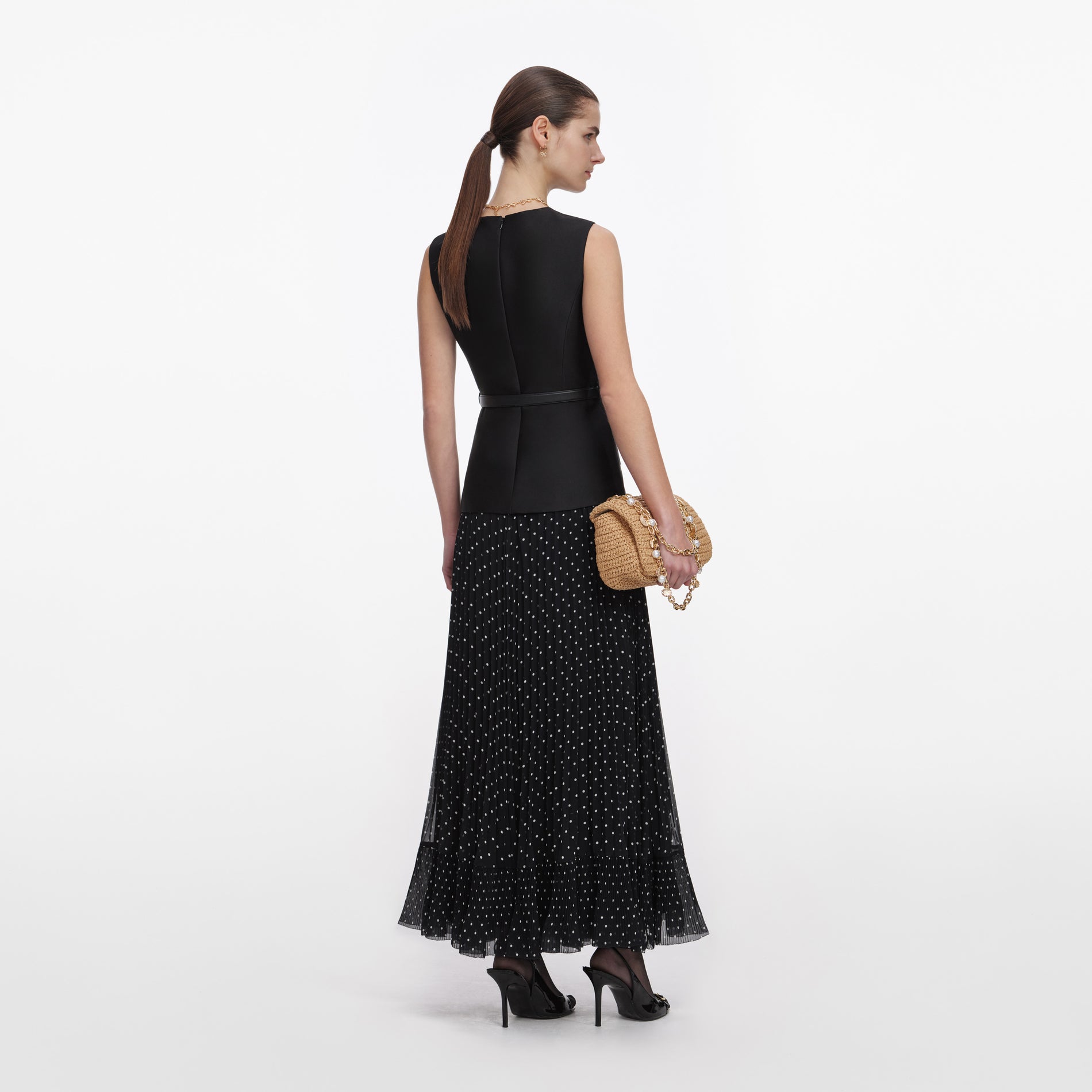 Back view of a woman wearing the Black Taffeta Polka Dot Midi Dress