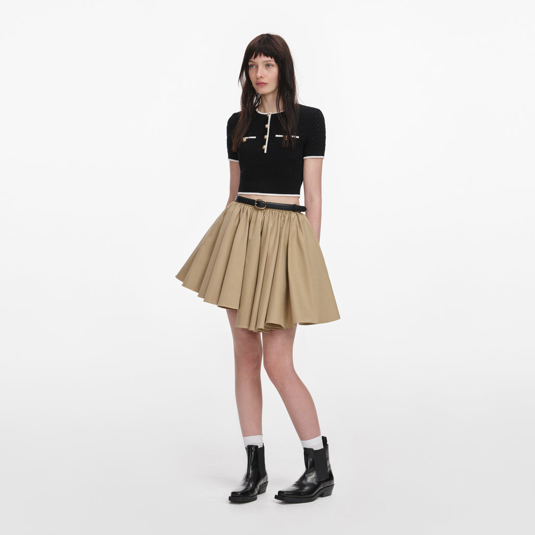 Side view of a woman wearing the Tan Cotton Mini Skirt
