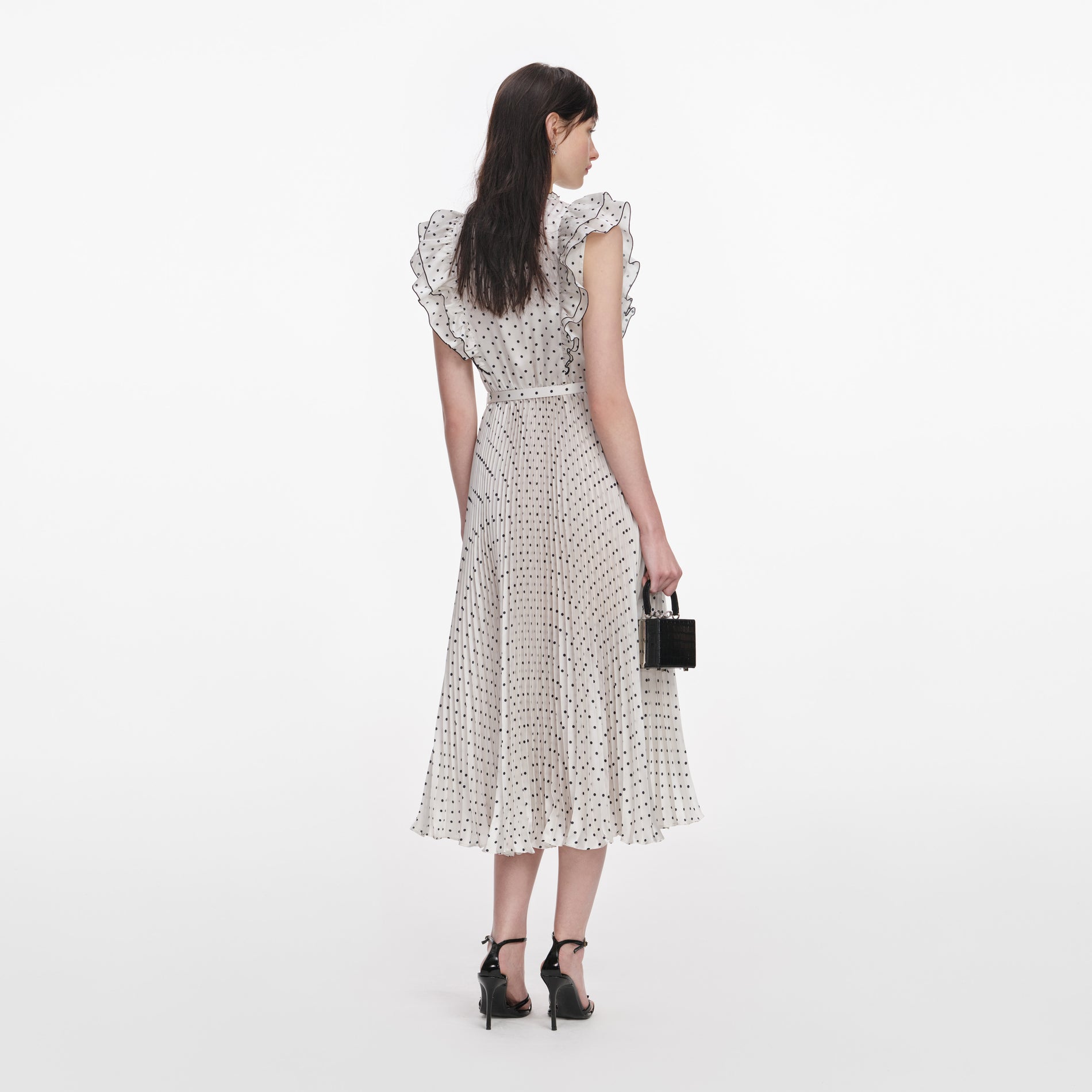 Back view of a woman wearing the Cream Ramie Polka Dot Midi Dress