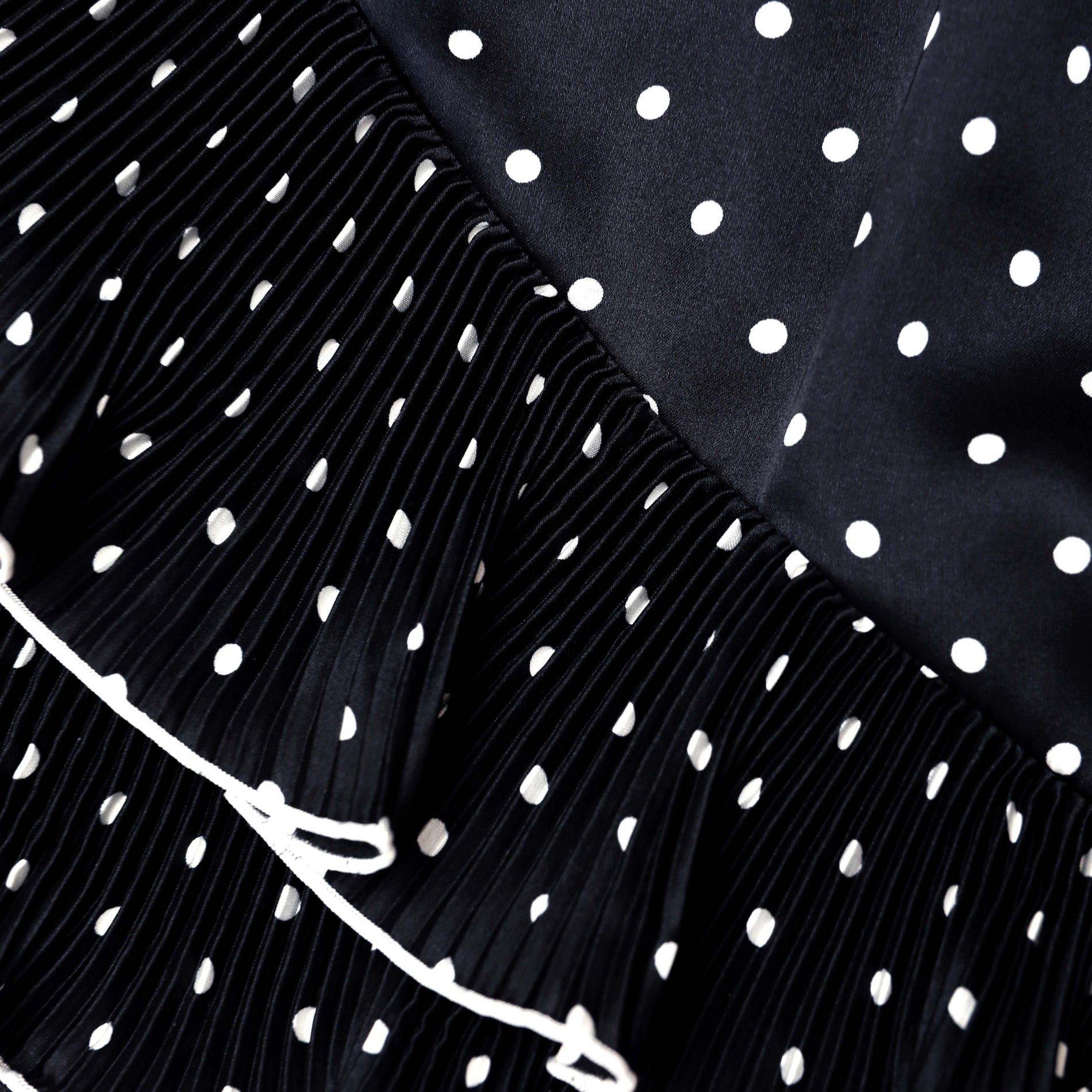 A close up of the fabric for the Black Polka Dot Frill Mini Skirt
