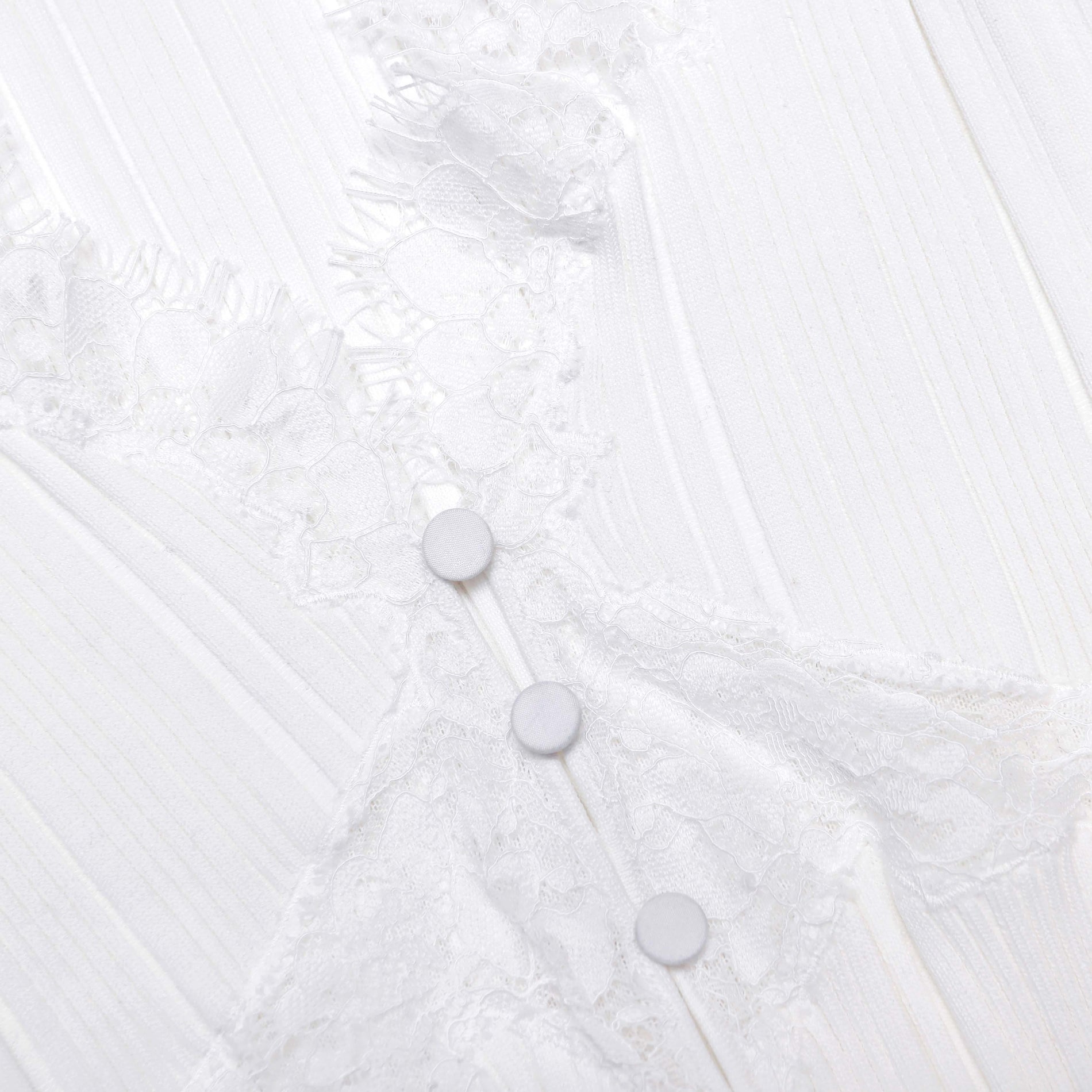 A close up of the fabric for the White Lace Trim Knit Top