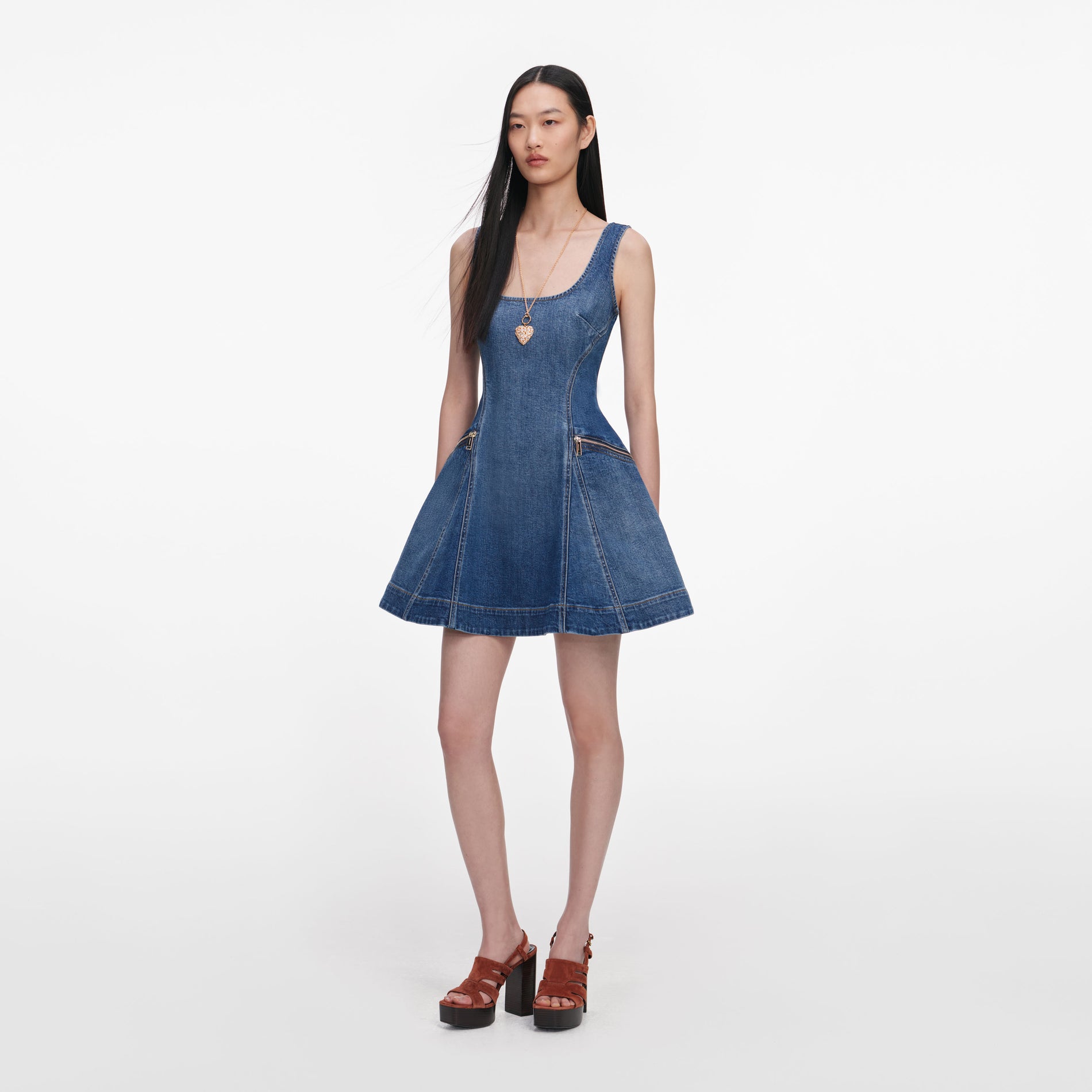 Side view of a woman wearing the Denim Flared Mini Dress
