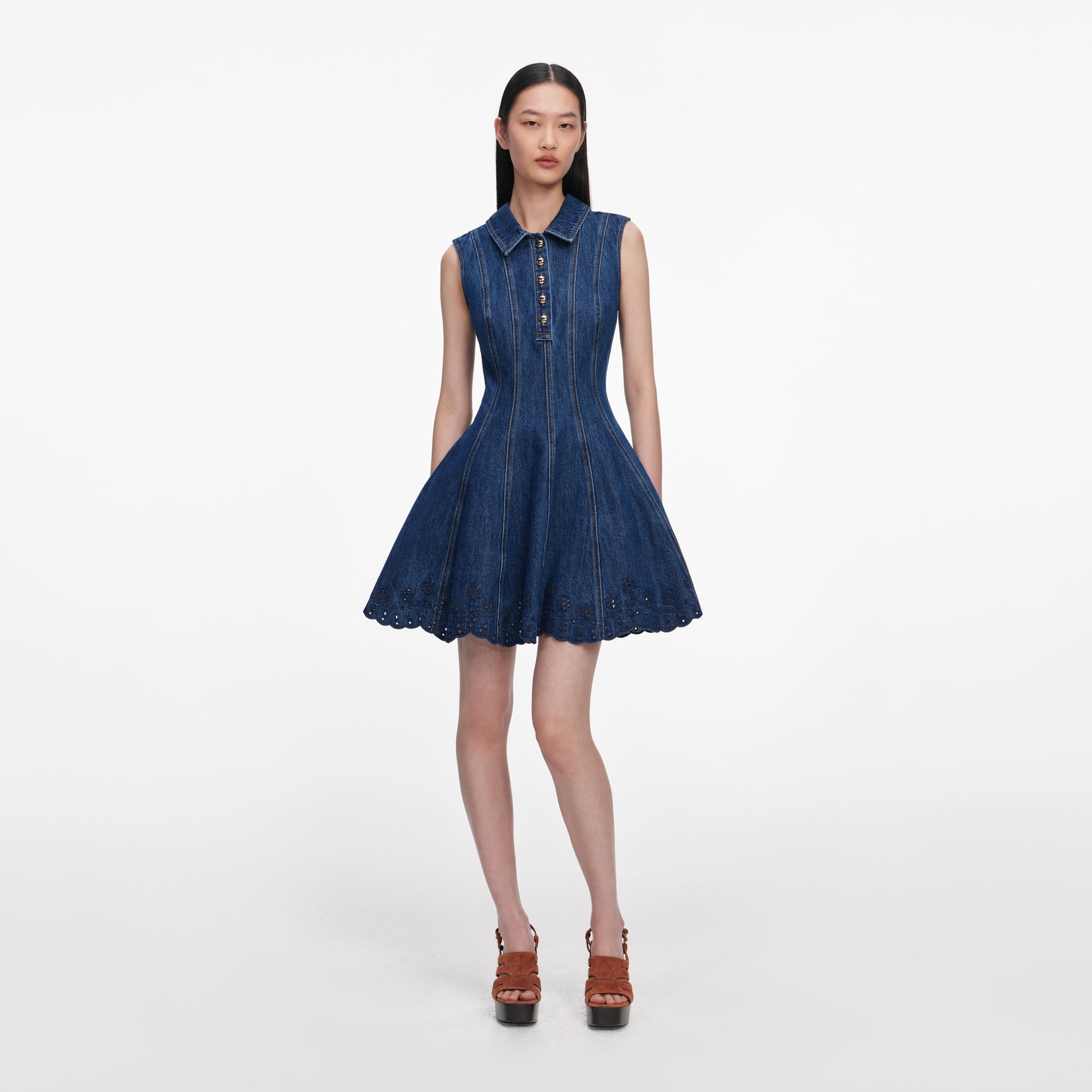 Front view of a woman wearing the Denim Broderie Mini Dress