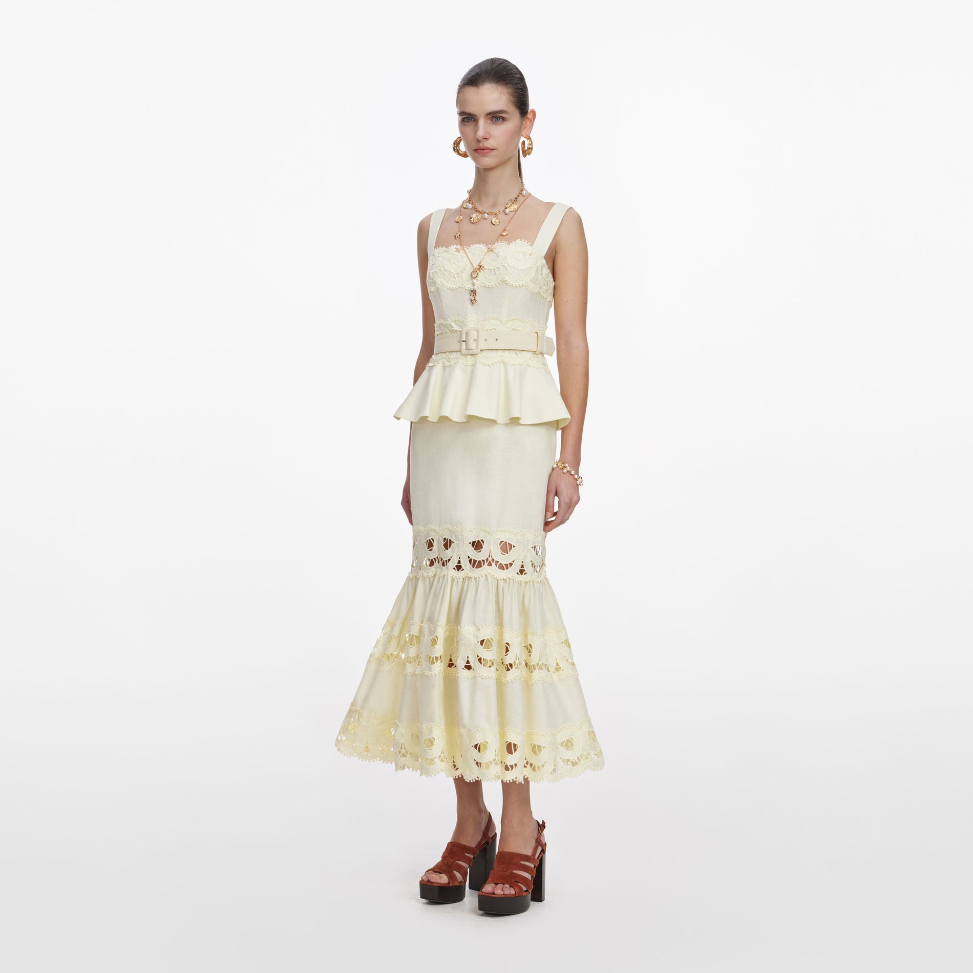 Side view of a woman wearing the Yellow Linen Peplum Midi Dress