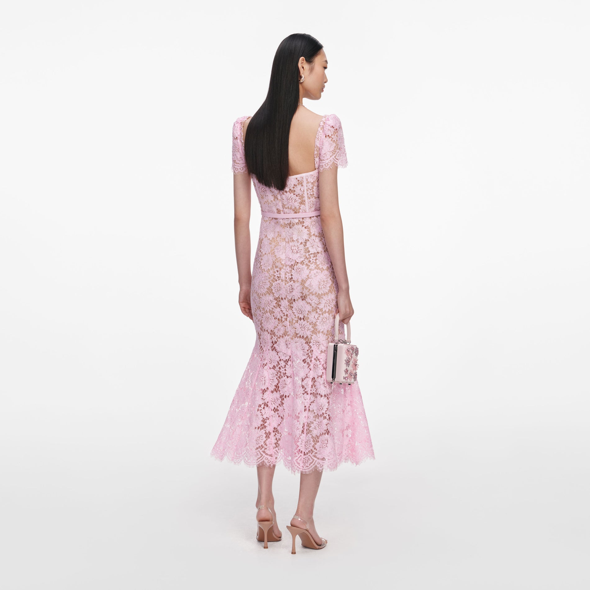 Back view of a woman wearing the Pink Fine Lace Midi Dress