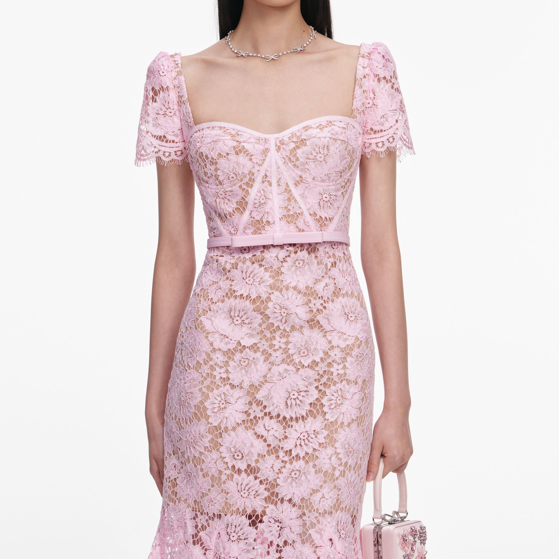 A close up of a woman wearing the Pink Fine Lace Midi Dress