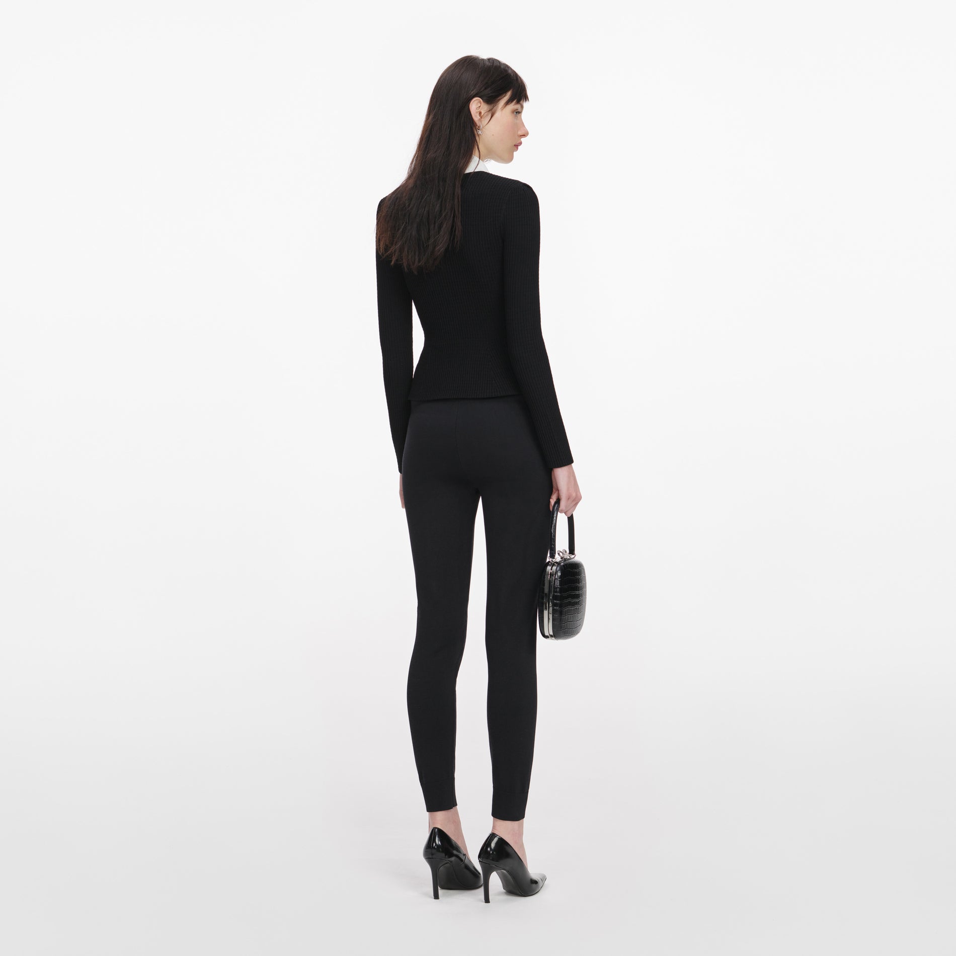 Back view of a woman wearing the Black Tailored Knit Top