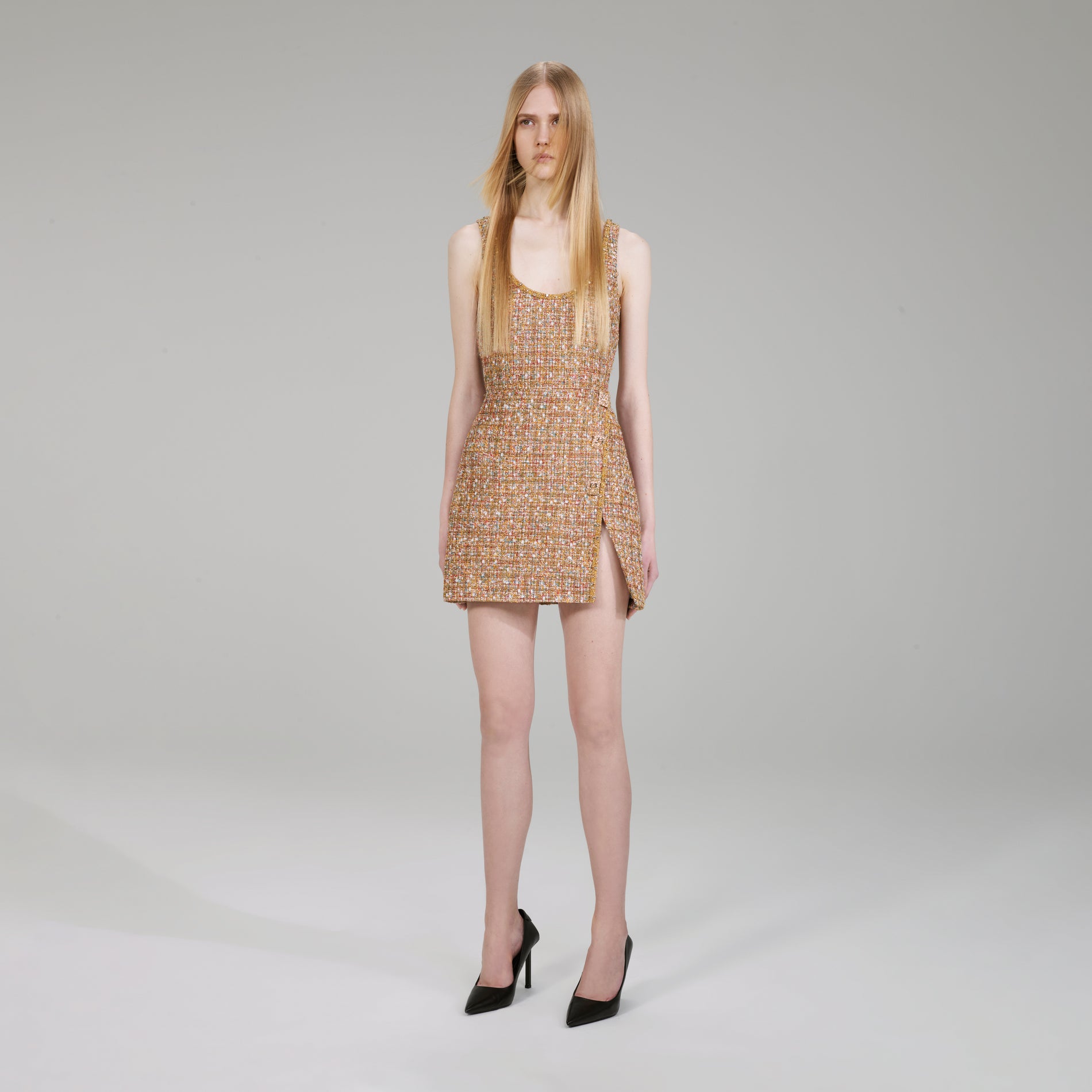 A woman wearing the Gold Tinsel Bouclé Mini Dress