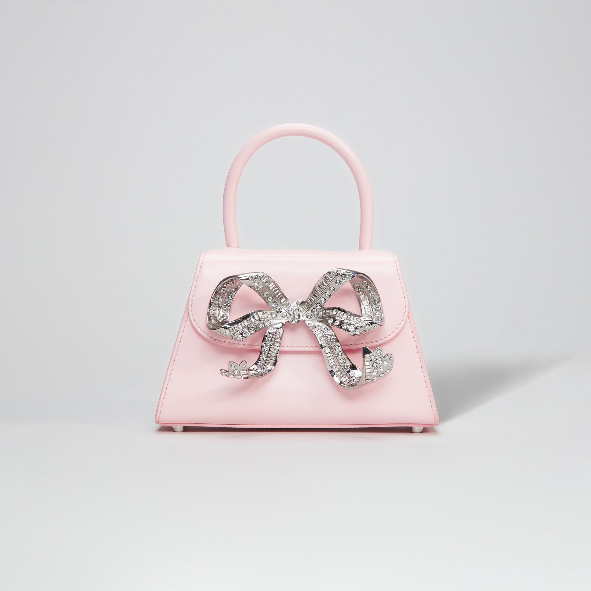 A woman wearing the The Bow Mini in Pink with Diamanté