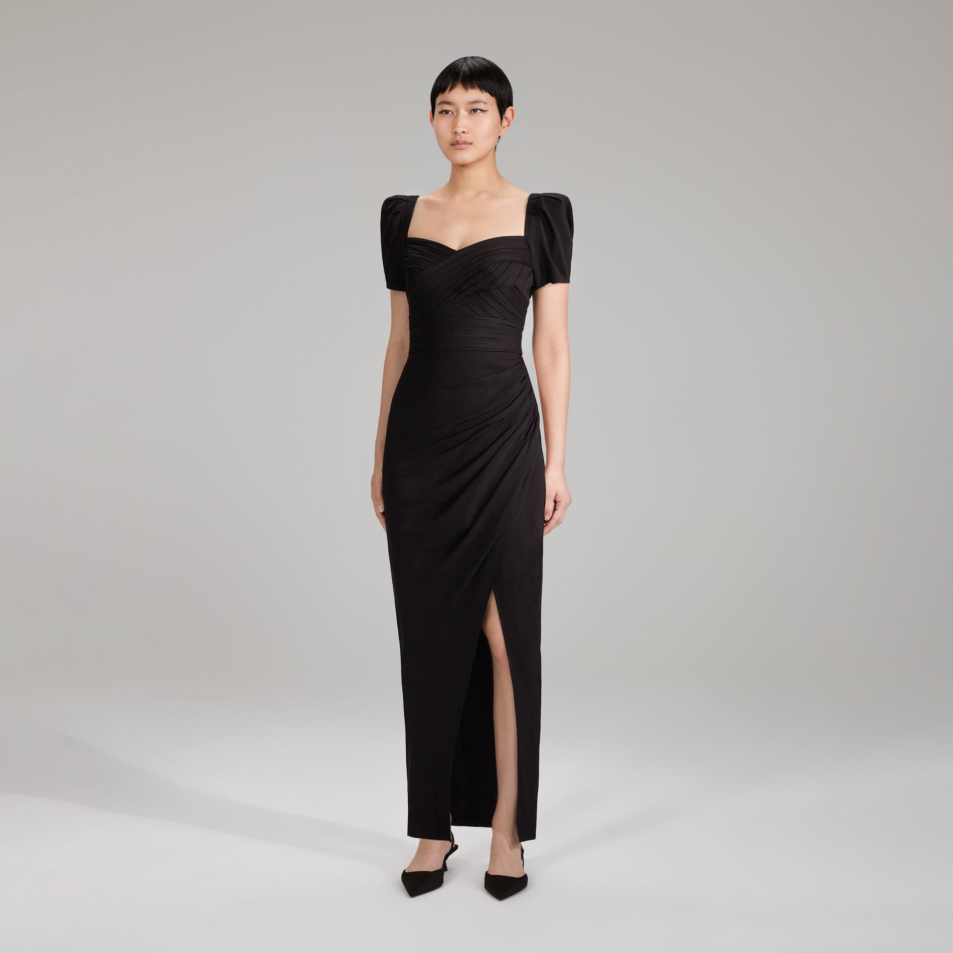 A woman wearing the Black Maxi Stretch Crepe Dress