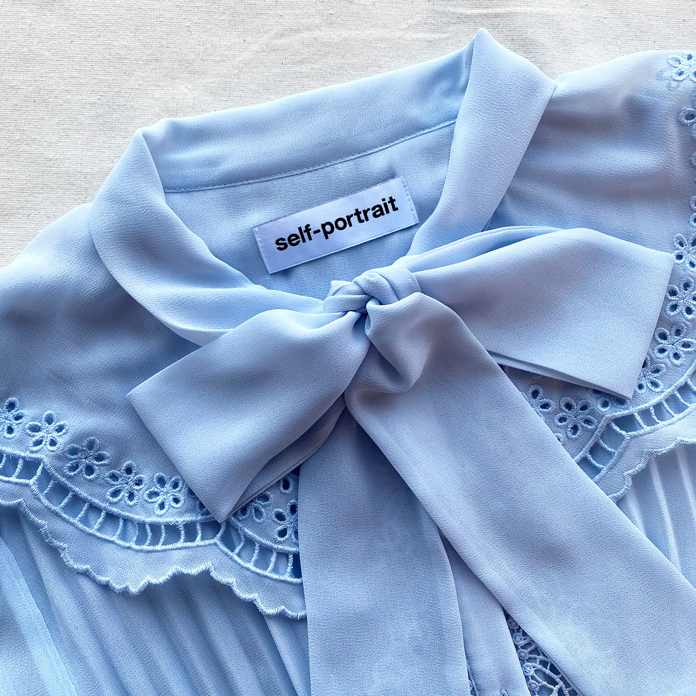 A close up of the fabric for the Blue Broderie Collar Chiffon Mini Dress