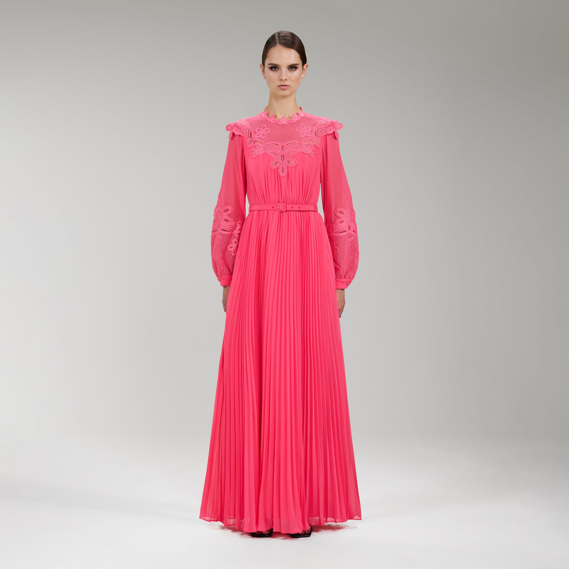 A woman wearing the Pink Chiffon Guipure Lace Bib Maxi Dress