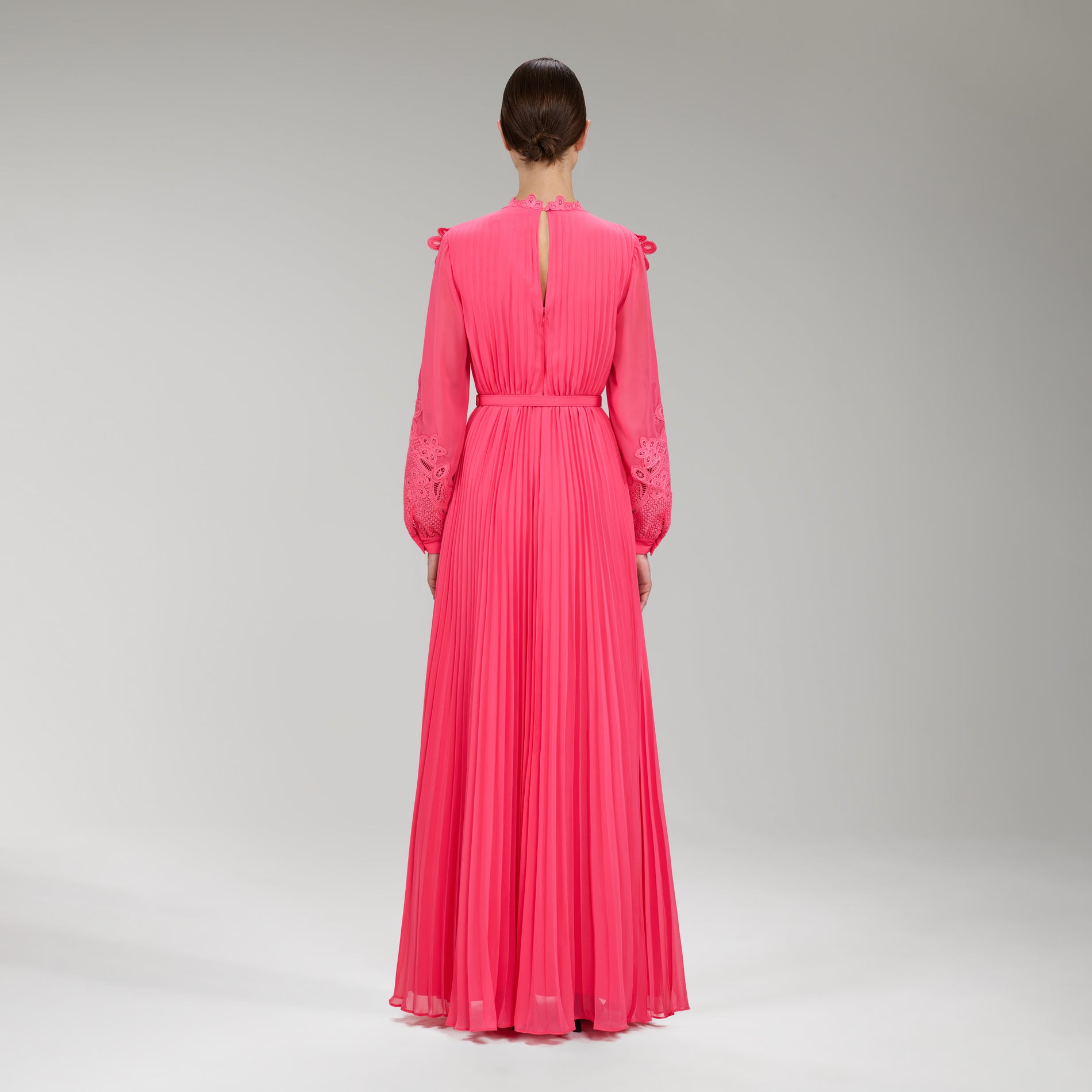 A woman wearing the Pink Chiffon Guipure Lace Bib Maxi Dress