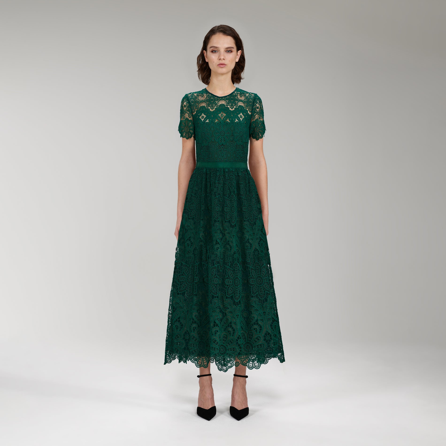 A woman wearing the Dark Green Floral Guipure Midi Dress