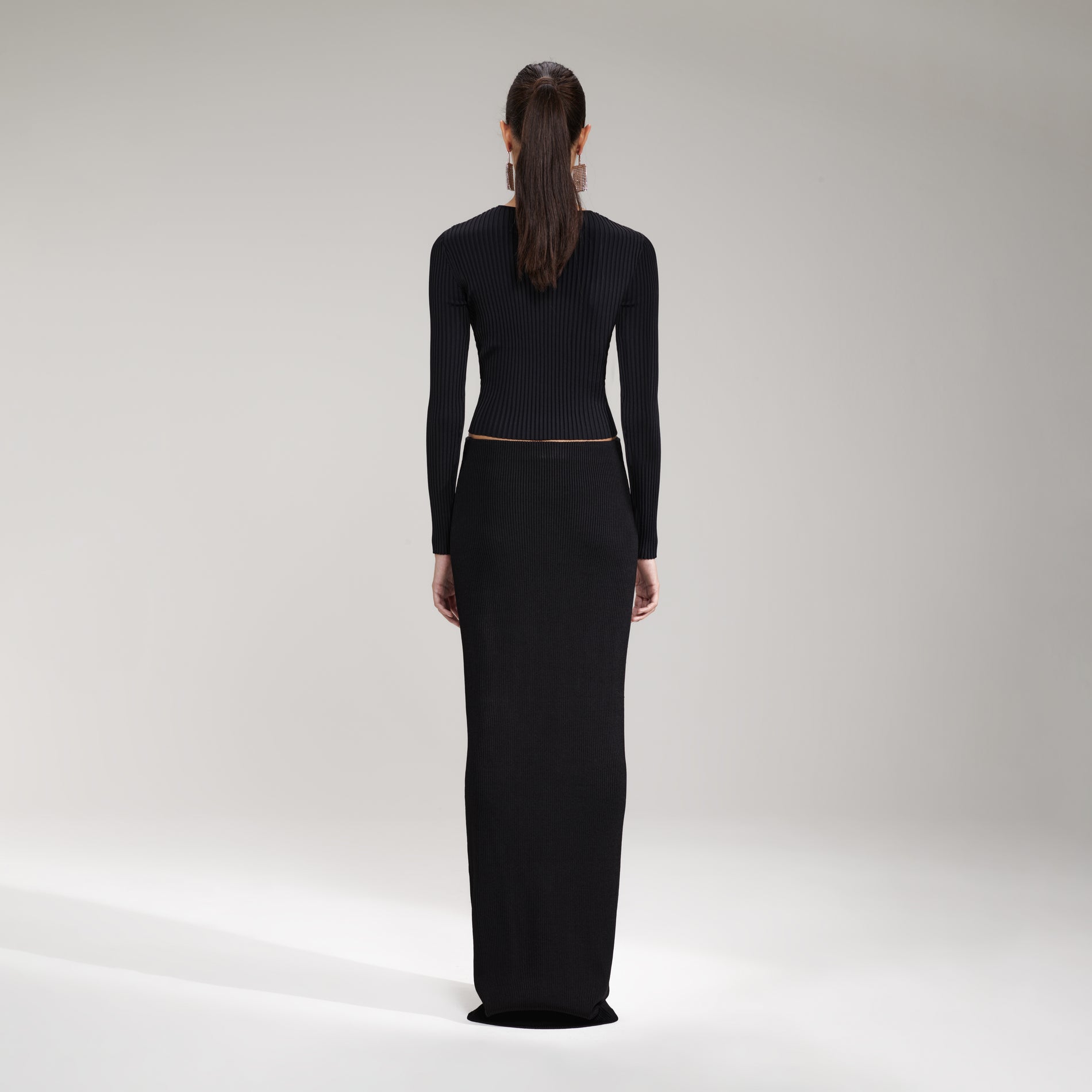 A woman wearing the Black Ribbed Knit Cut Out Top