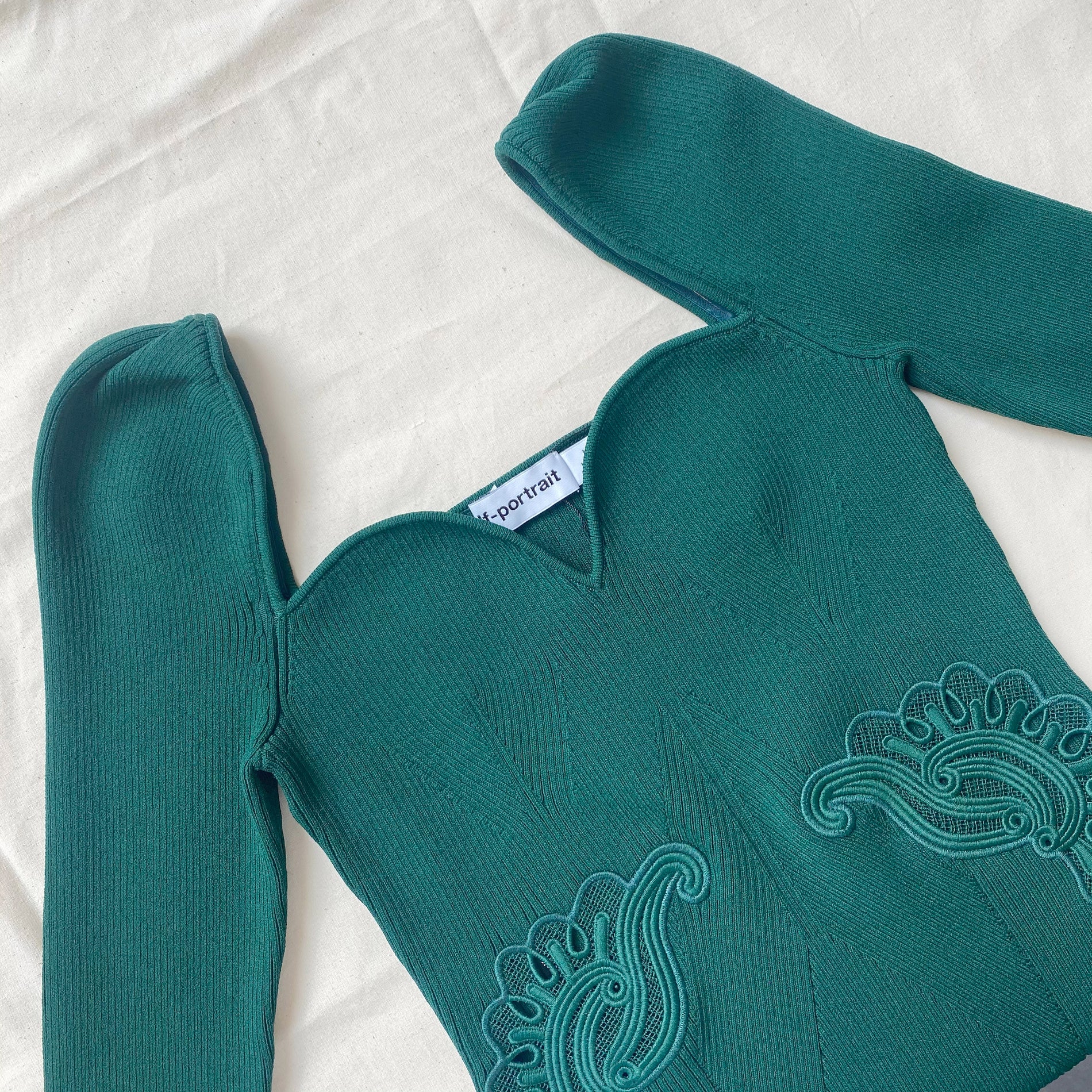 A close up of the fabric for the Dark Green Inserted Lace Ribbed Knit Mini Dress