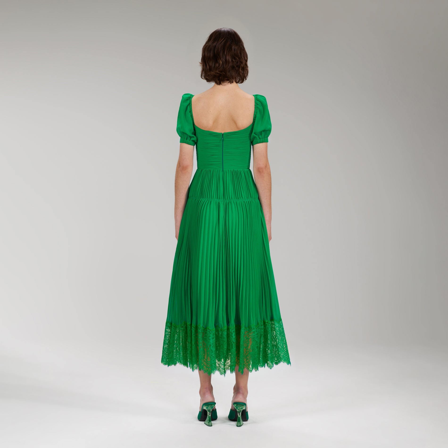 A woman wearing the Bright Green Chiffon Cut Out Midi Dress