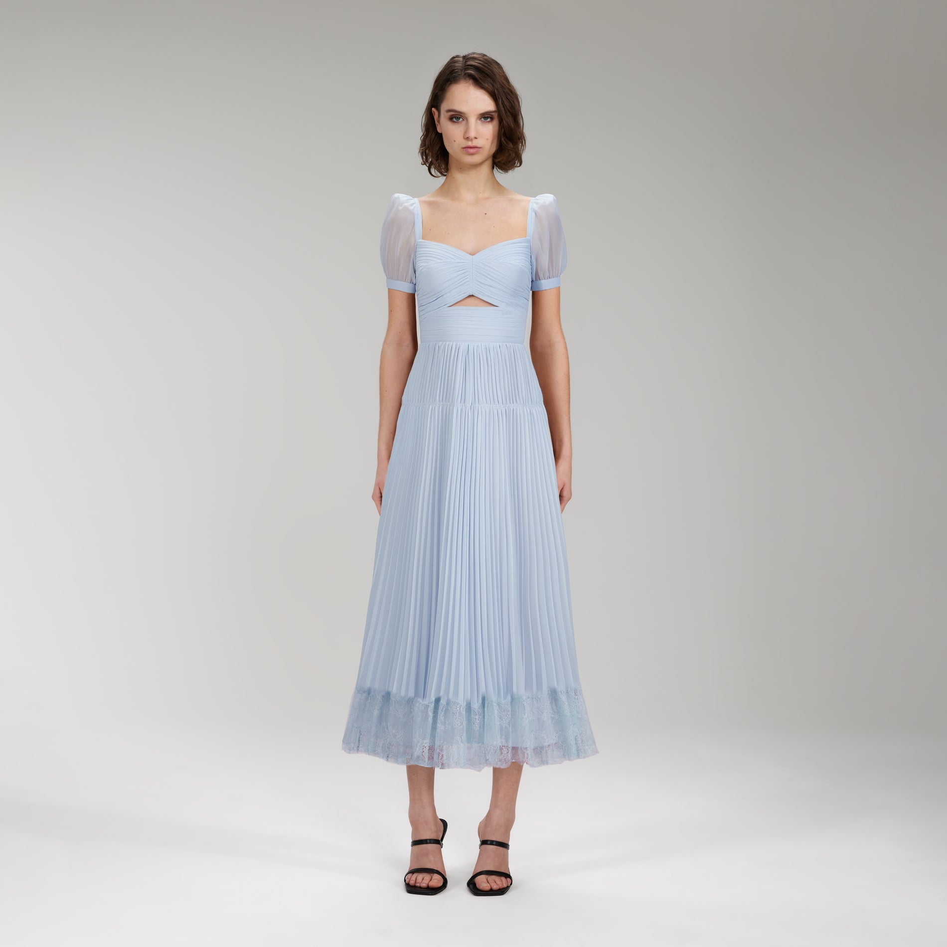 A woman wearing the Light Blue Chiffon Cut Out Midi Dress