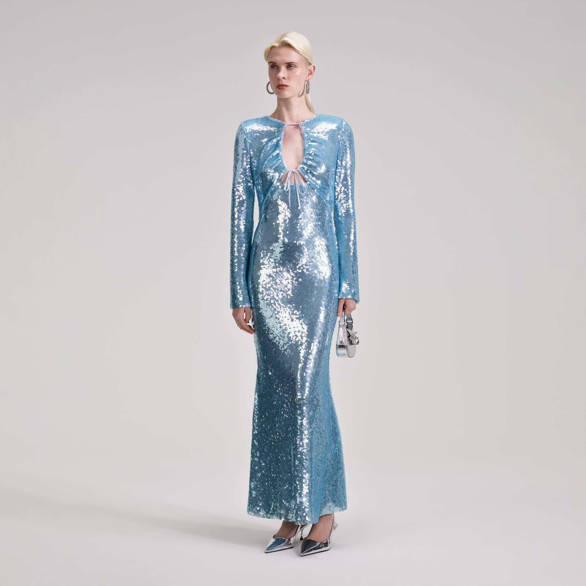 A woman wearing the Blue Sequin Maxi Dress