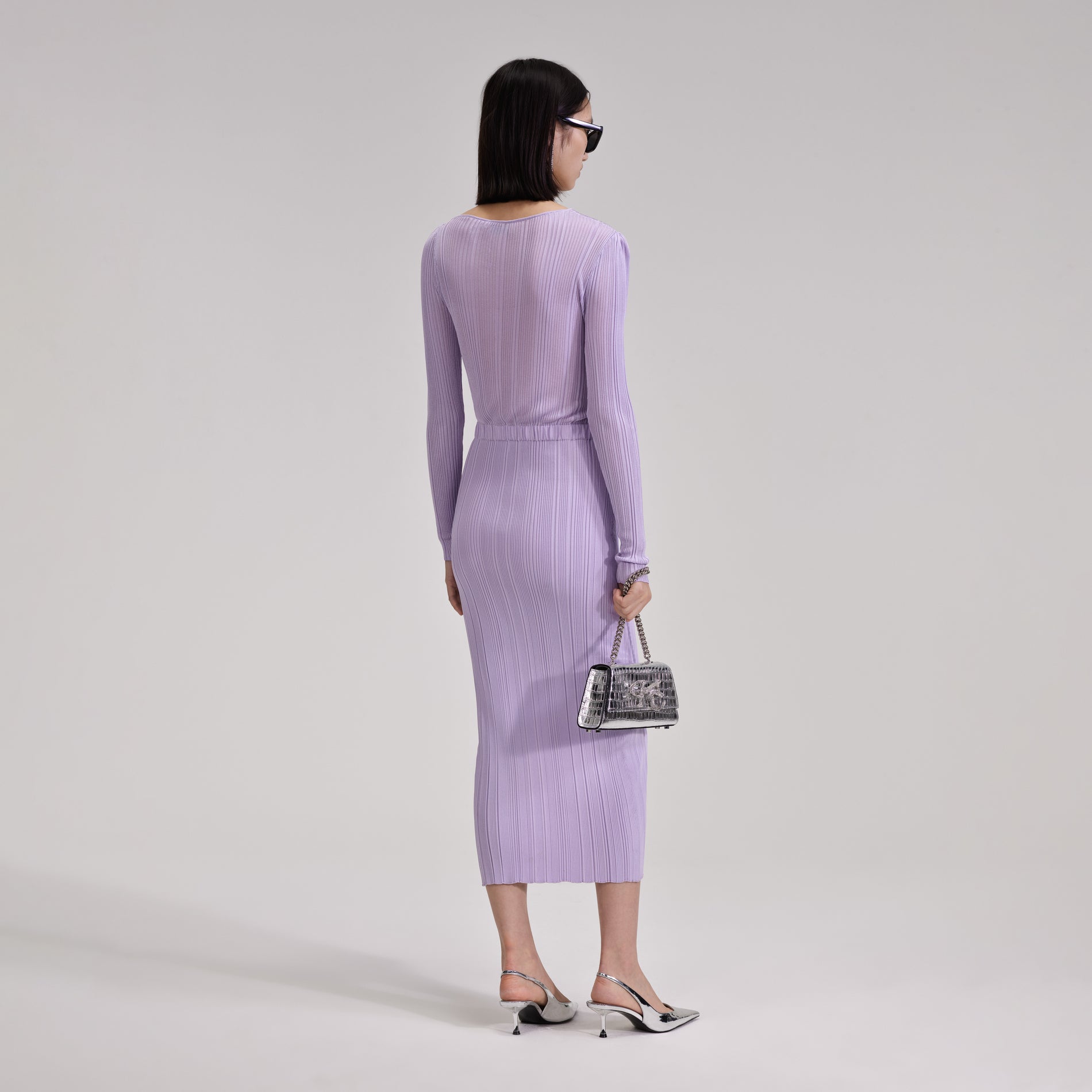 A woman wearing the Lilac Knit Midi Dress