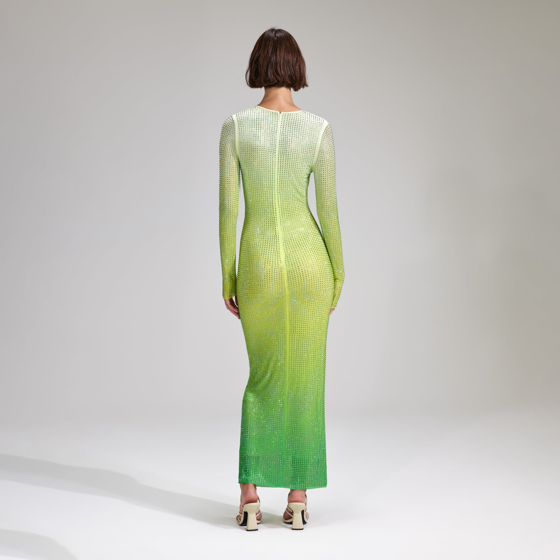A woman wearing the Green Rhinestone Mesh Keyhole Maxi Dress