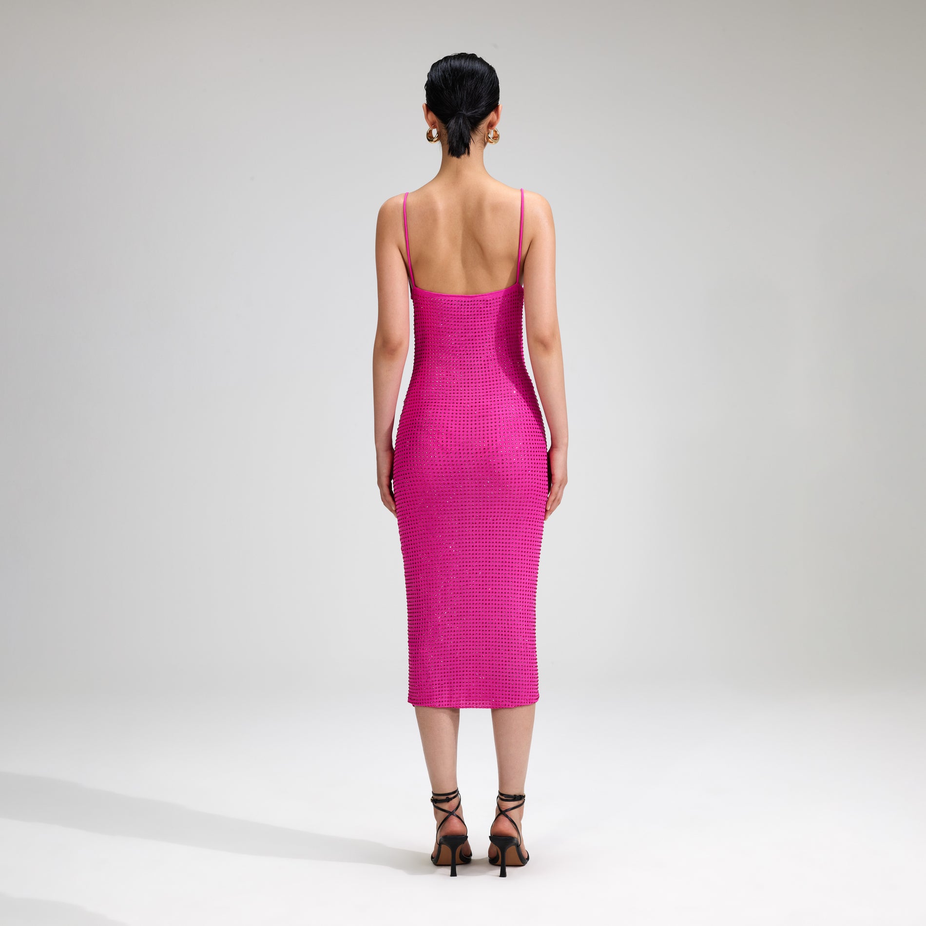 A woman wearing the Pink Rhinestone Midi Dress
