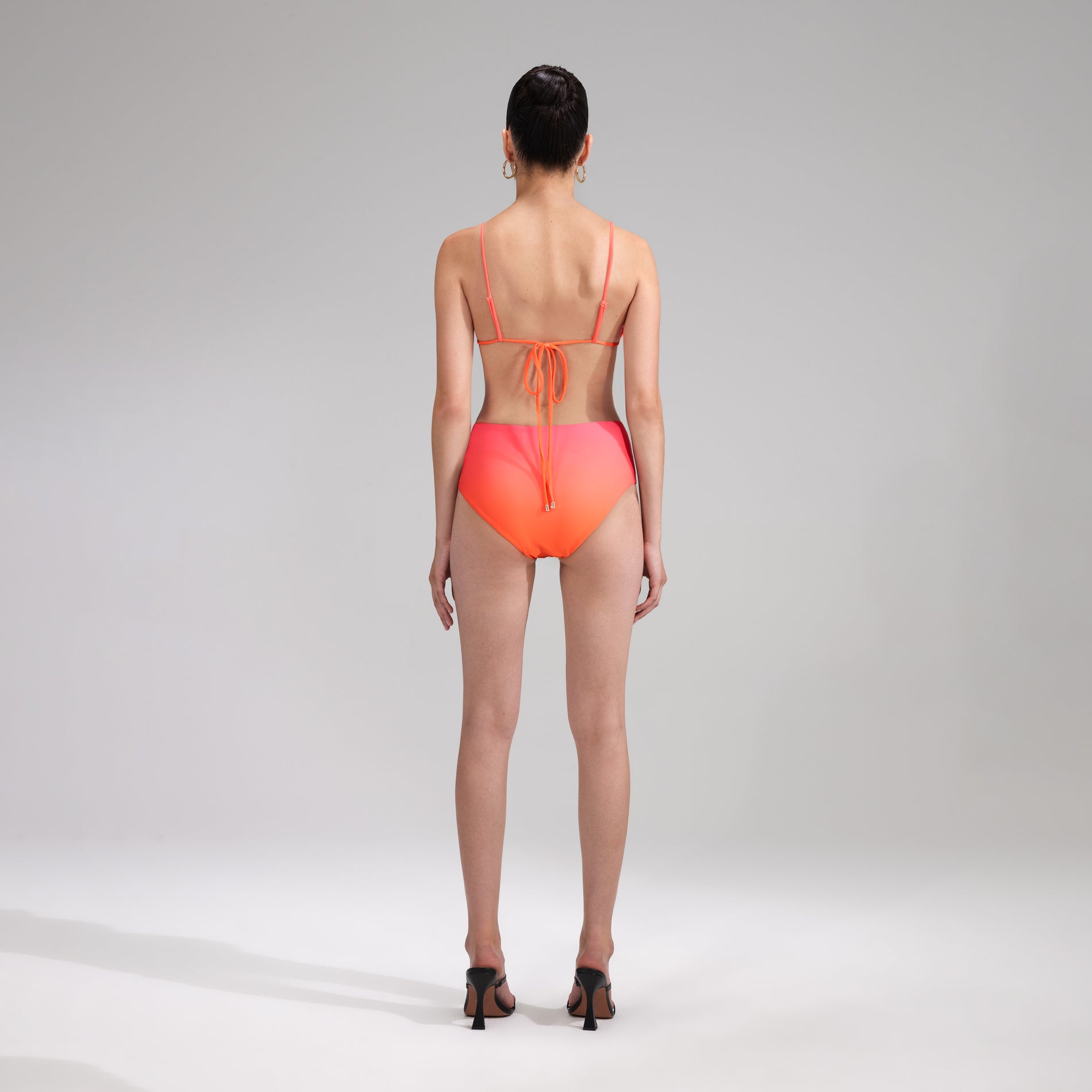 A woman wearing the Orange Bikini Brief