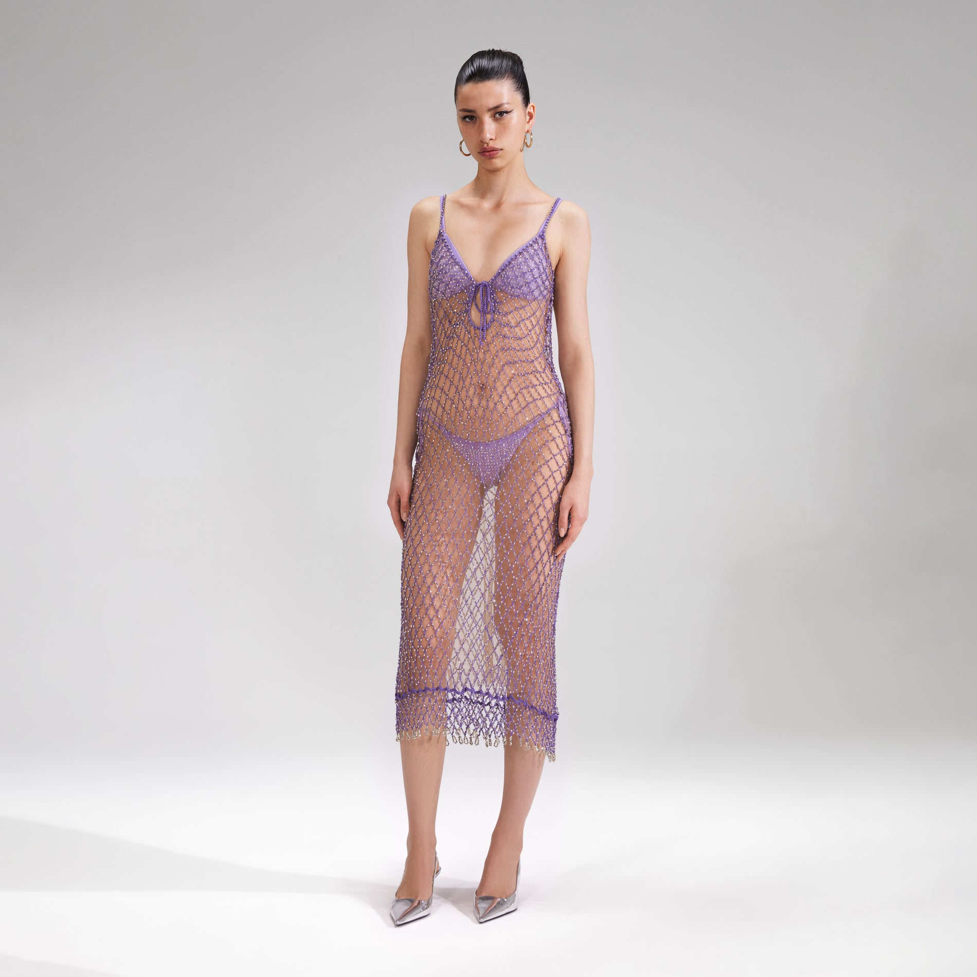 A woman wearing the Purple Beaded Fishnet Midi Dress