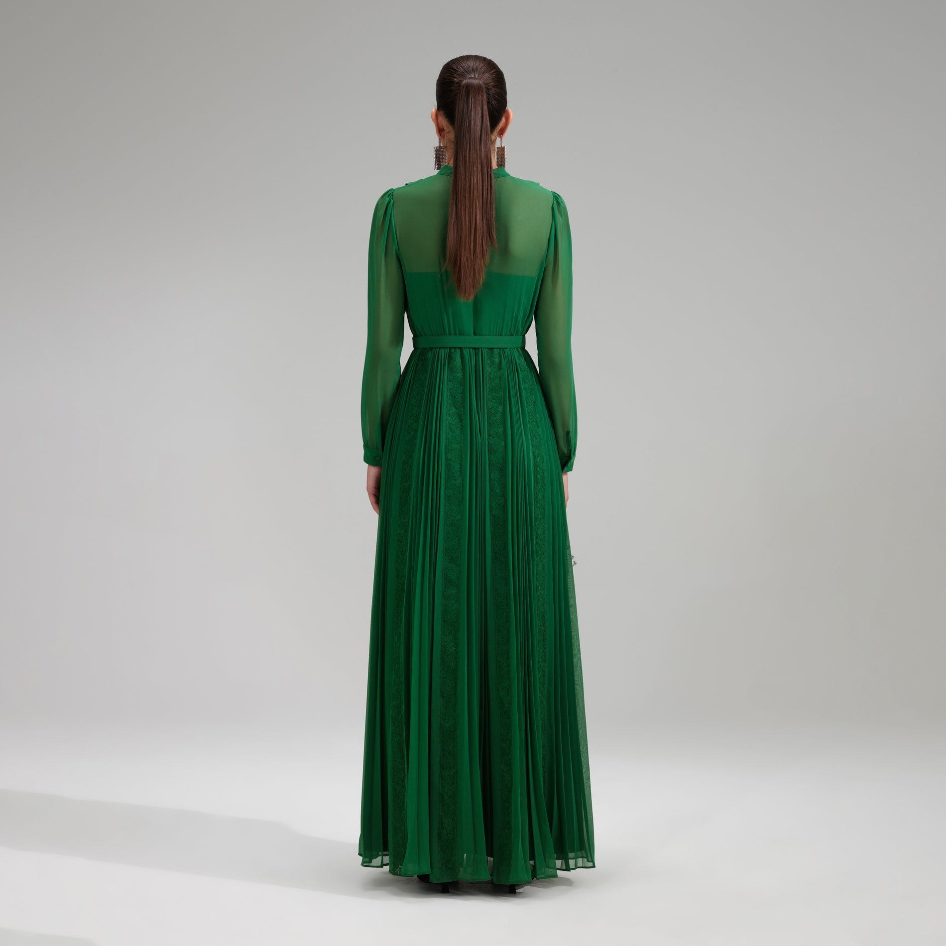 A woman wearing the Green Pleated Rhinestone Detail Maxi Dress