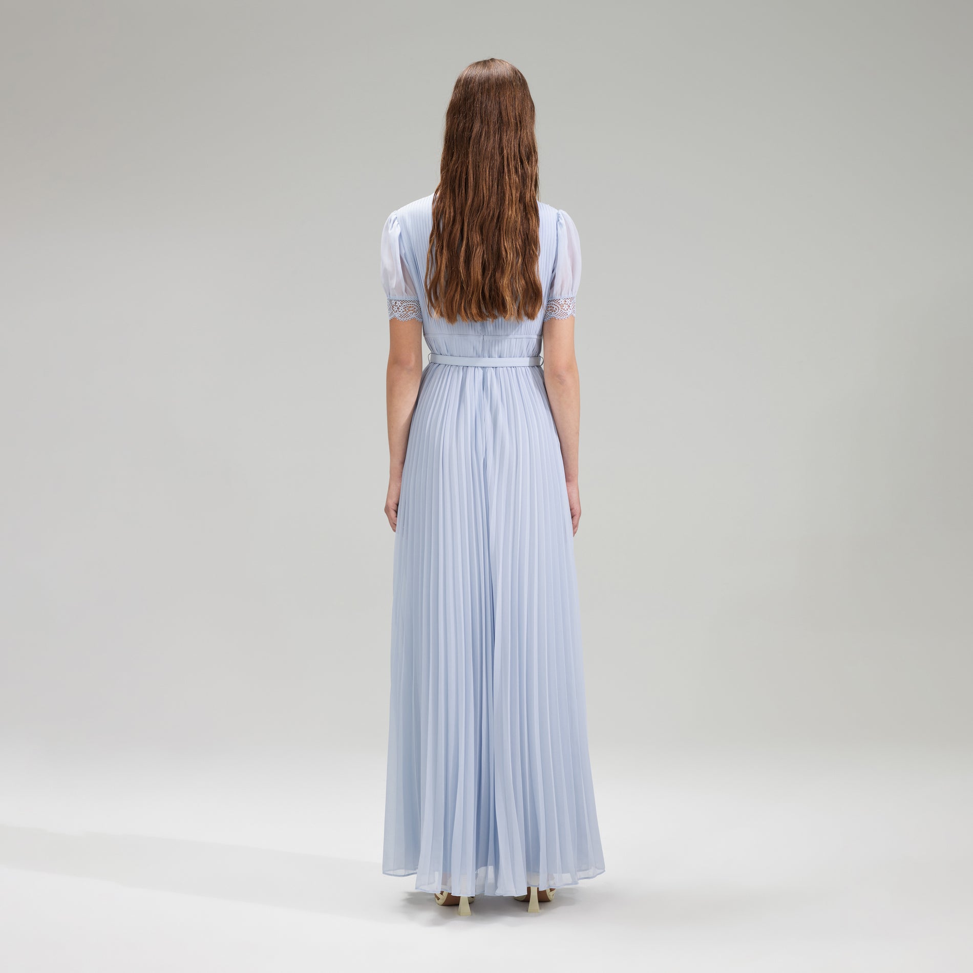 A woman wearing the Blue Chiffon Pleated Maxi Dress