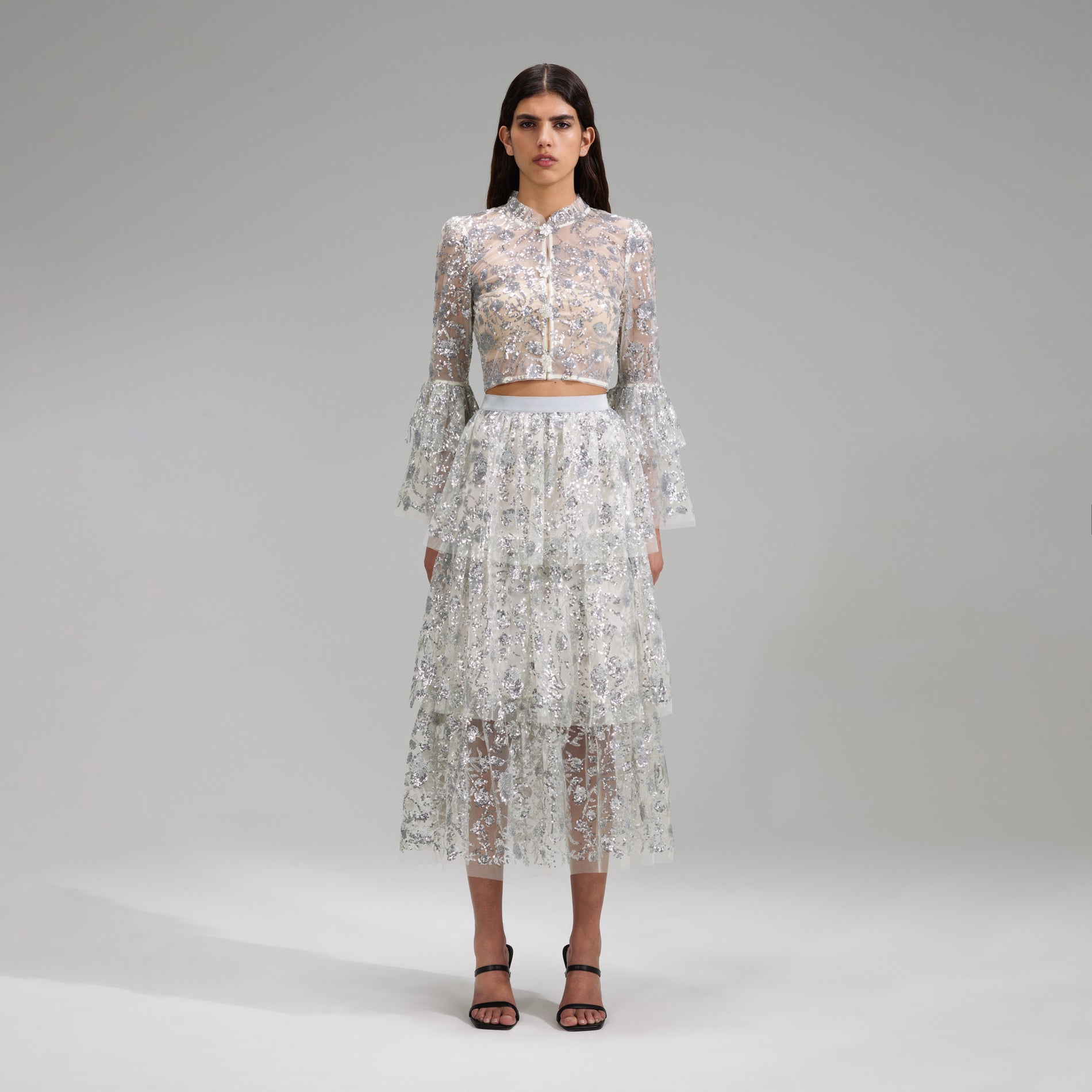 A woman wearing the Champagne Sequinned Tiered Midi Skirt