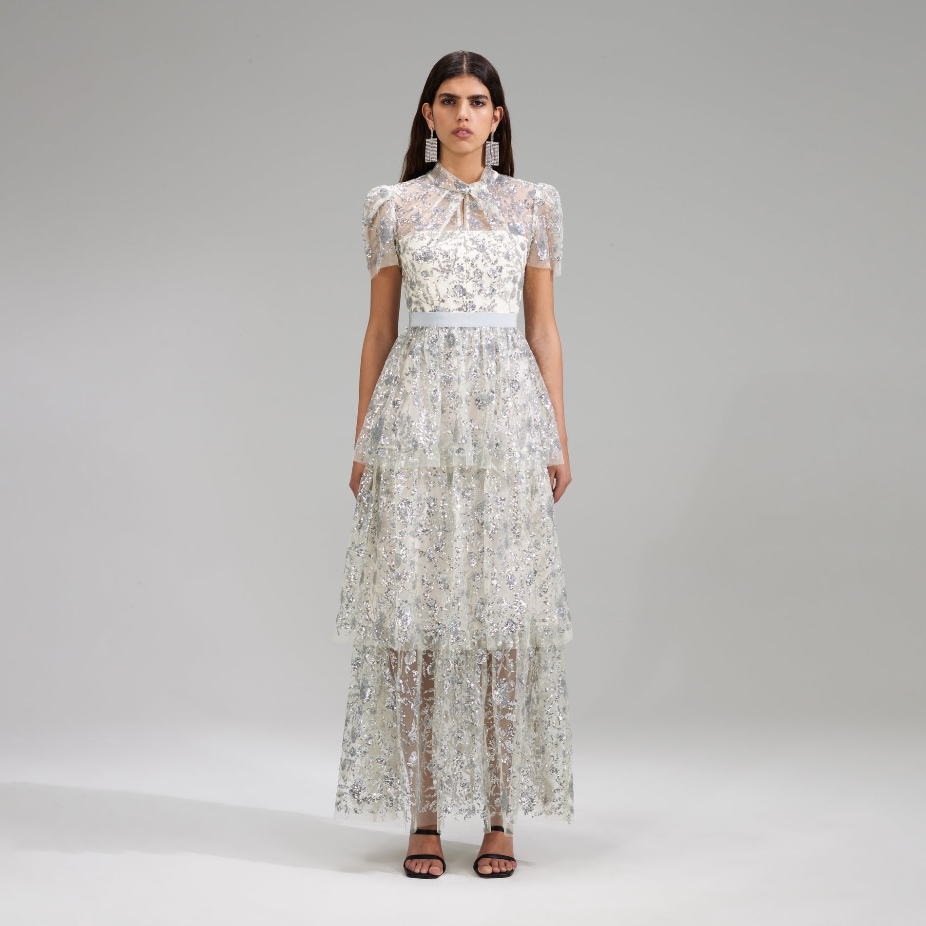 A woman wearing the Champagne Sequinned Tiered Maxi Dress