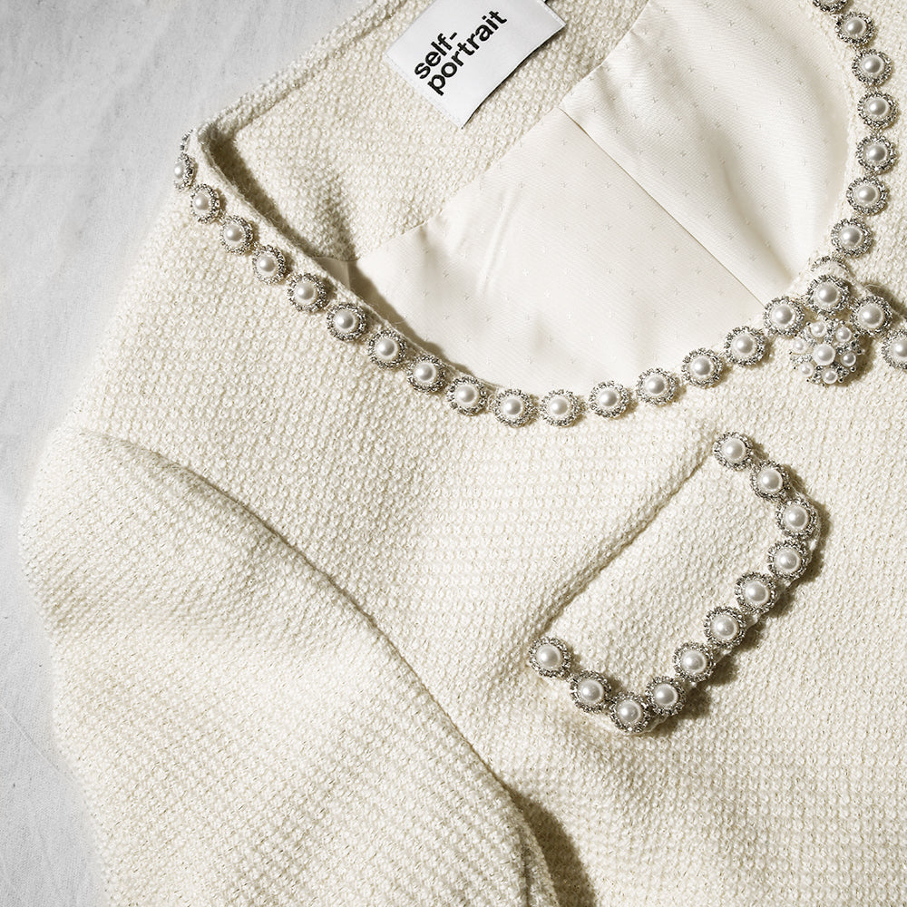 A close up of the fabric for the Cream Boucle Tailored Mini Dress