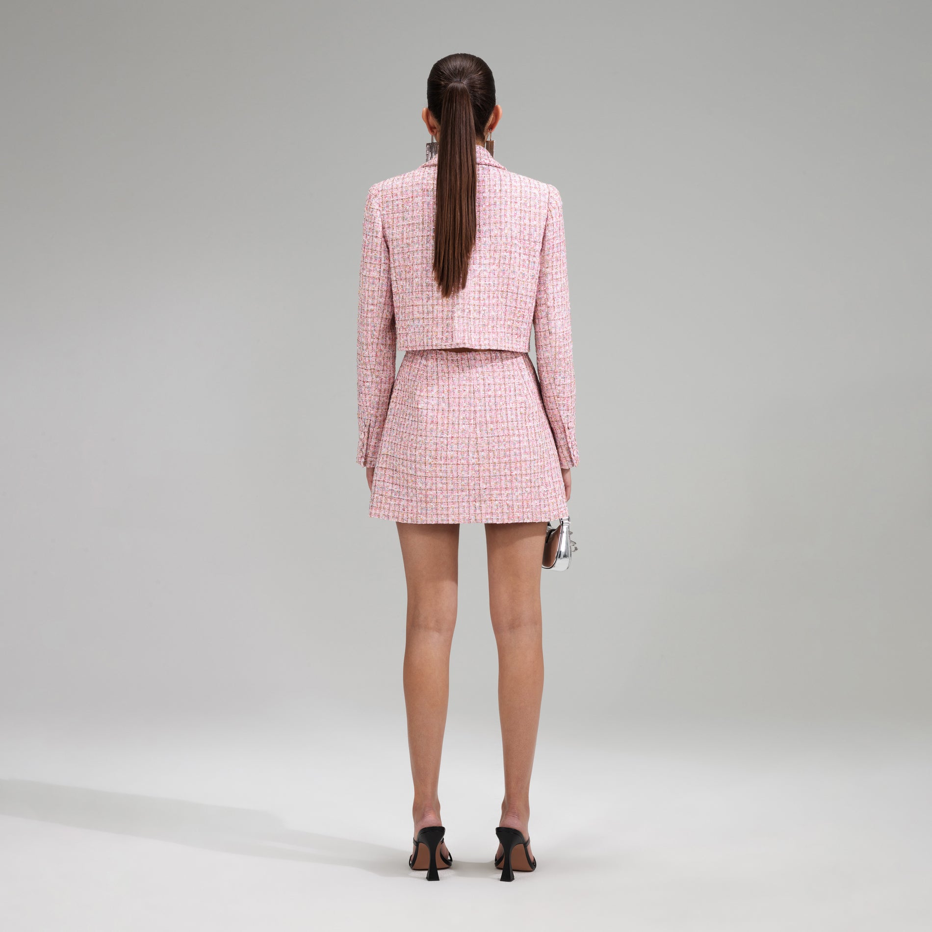 A woman wearing the Pink V Neck Boucle Tailored Mini Dress
