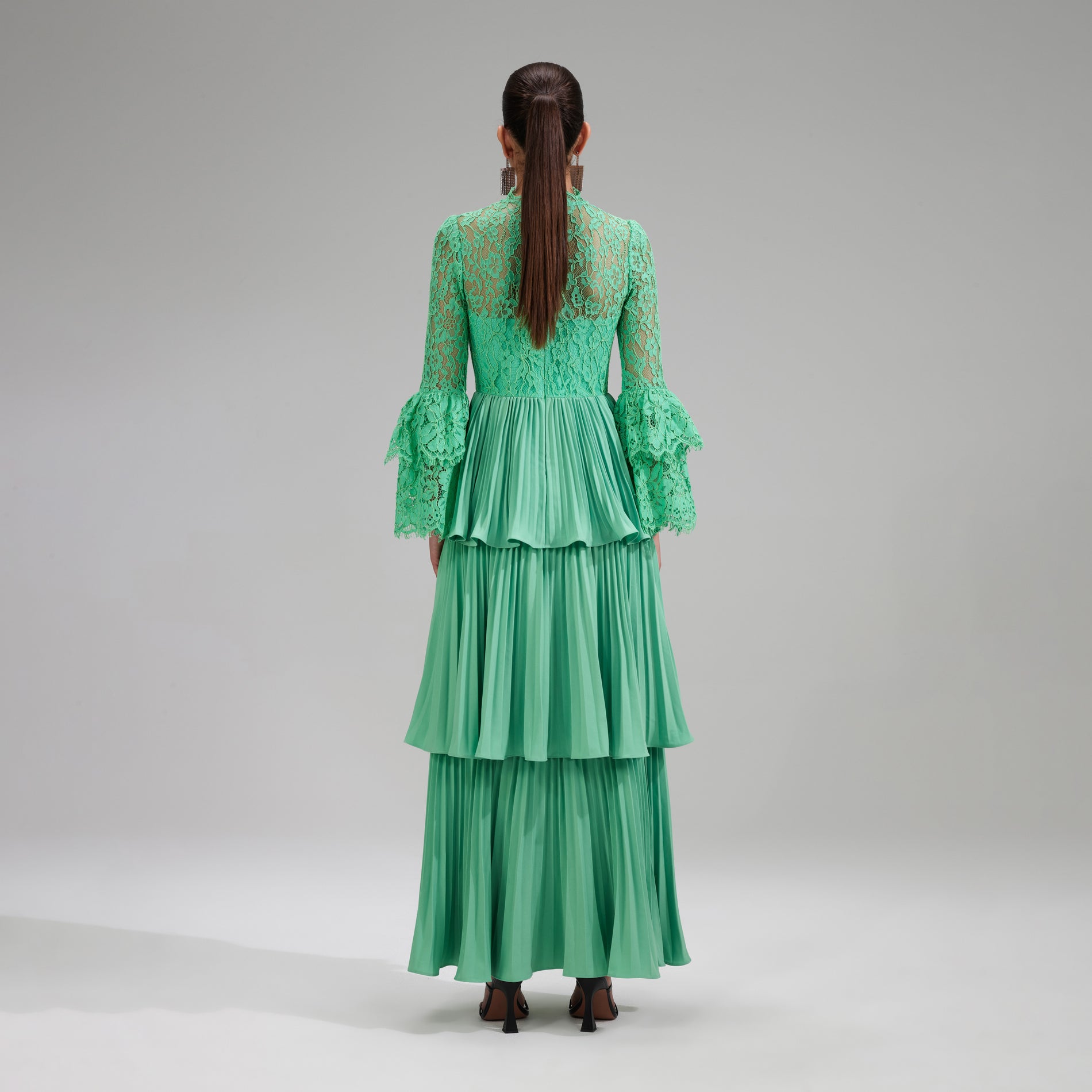 A woman wearing the Green Tiered Cord Lace Maxi Dress
