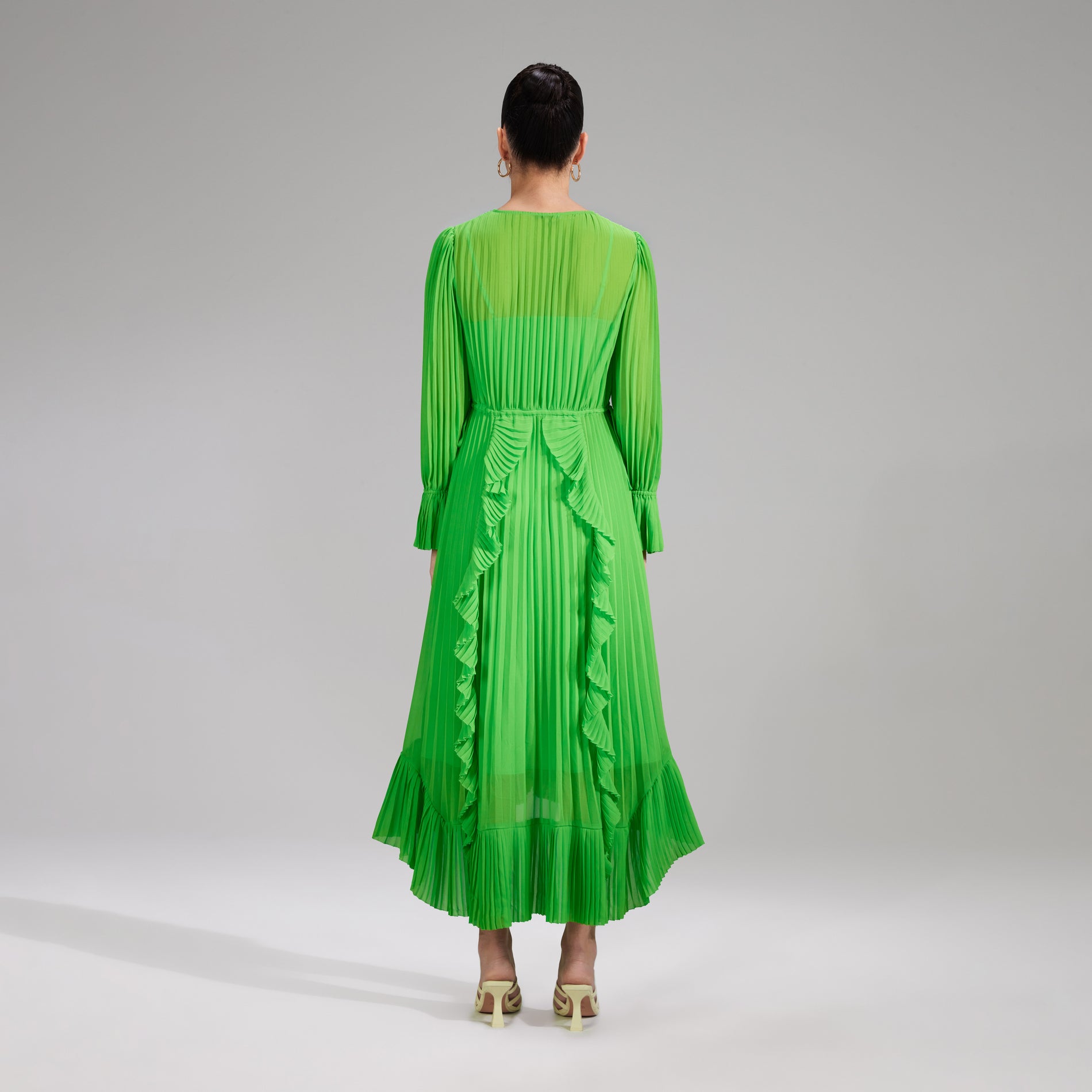 A woman wearing the Green Chiffon Ruffle Midi Dress