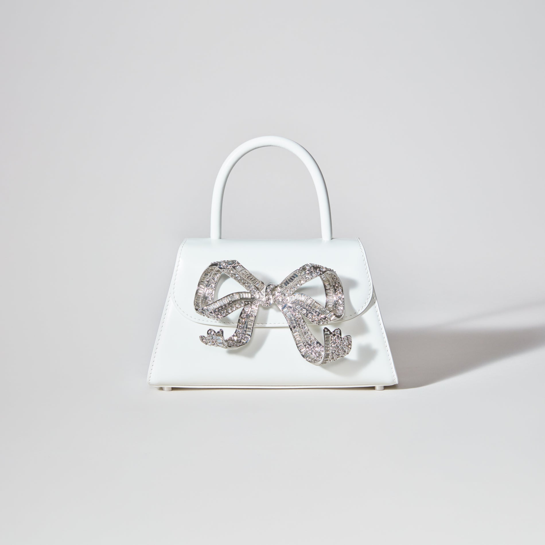 A woman wearing the The Bow Mini in White with Diamanté