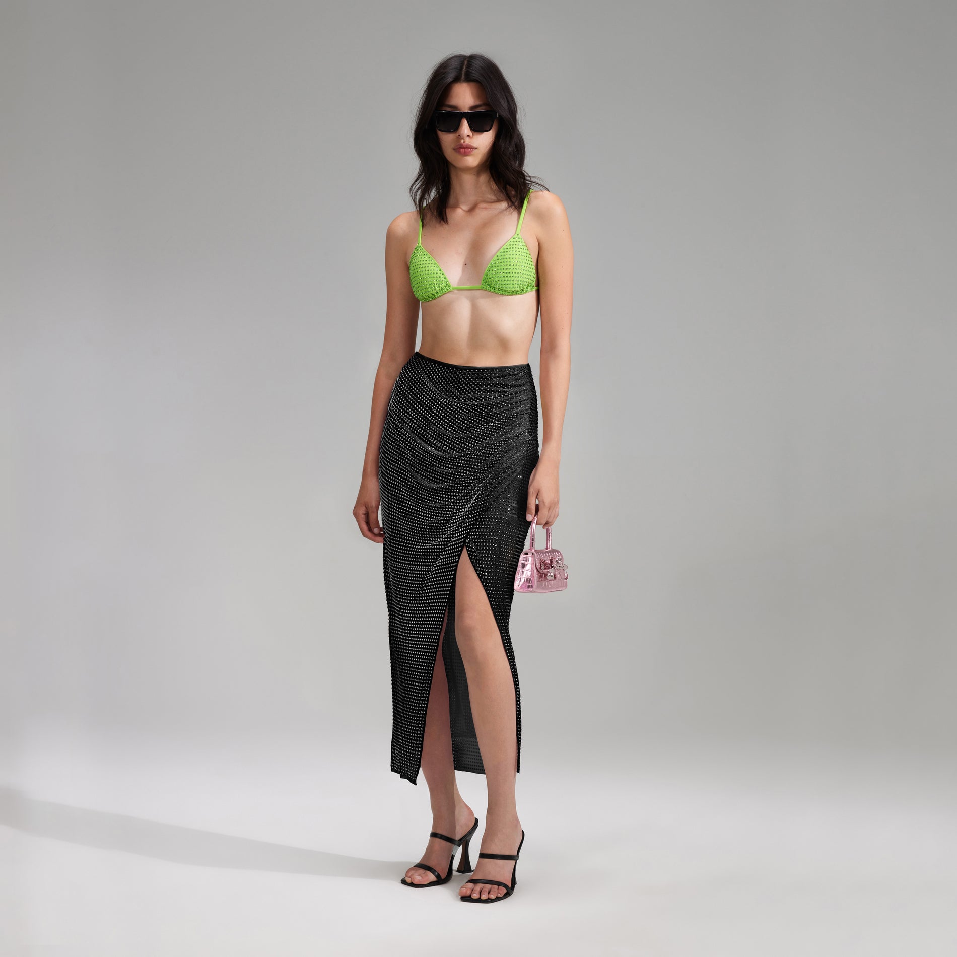 A woman wearing the Green Rhinestone Triangle Bikini Top
