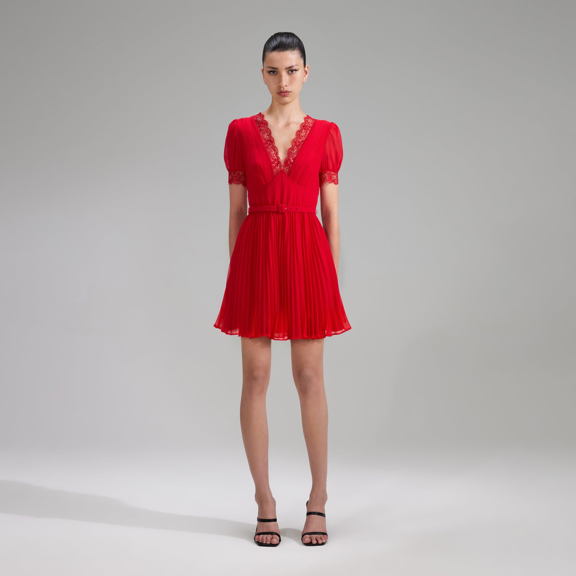 A woman wearing the Red Chiffon V Neck Mini Dress