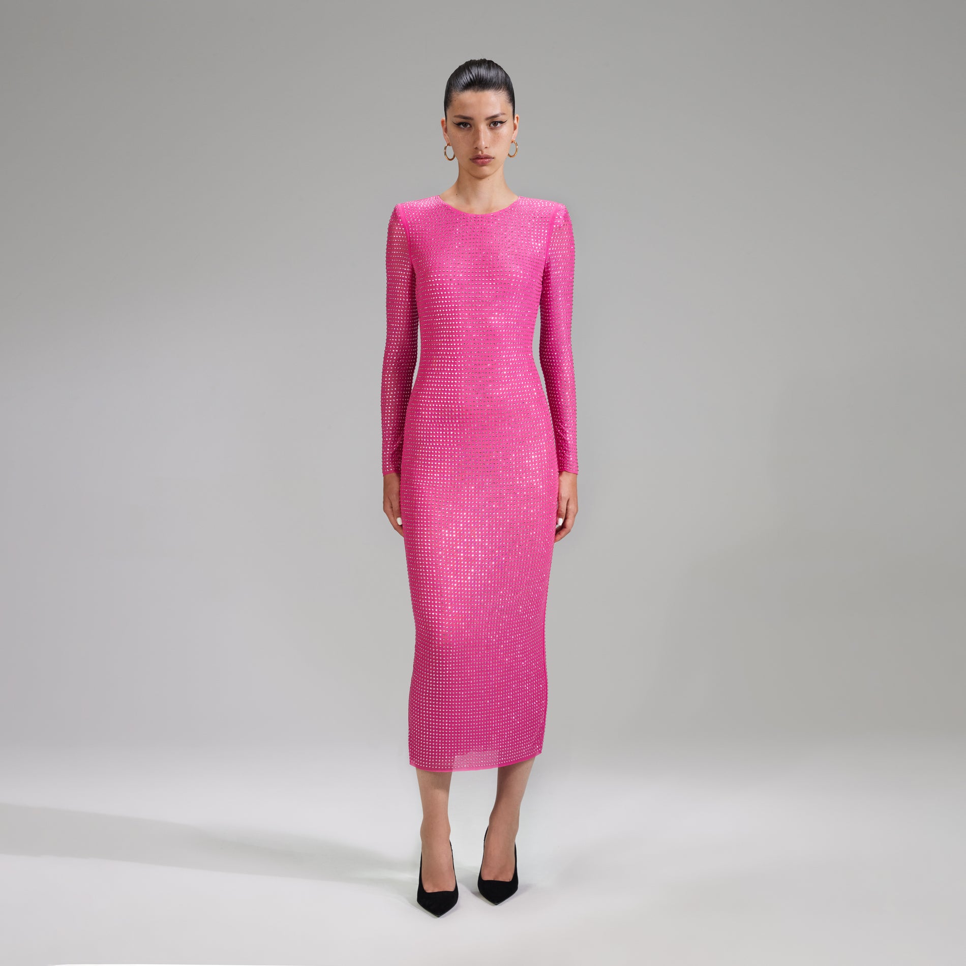 A woman wearing the Pink Rhinestone Mesh Midi Dress