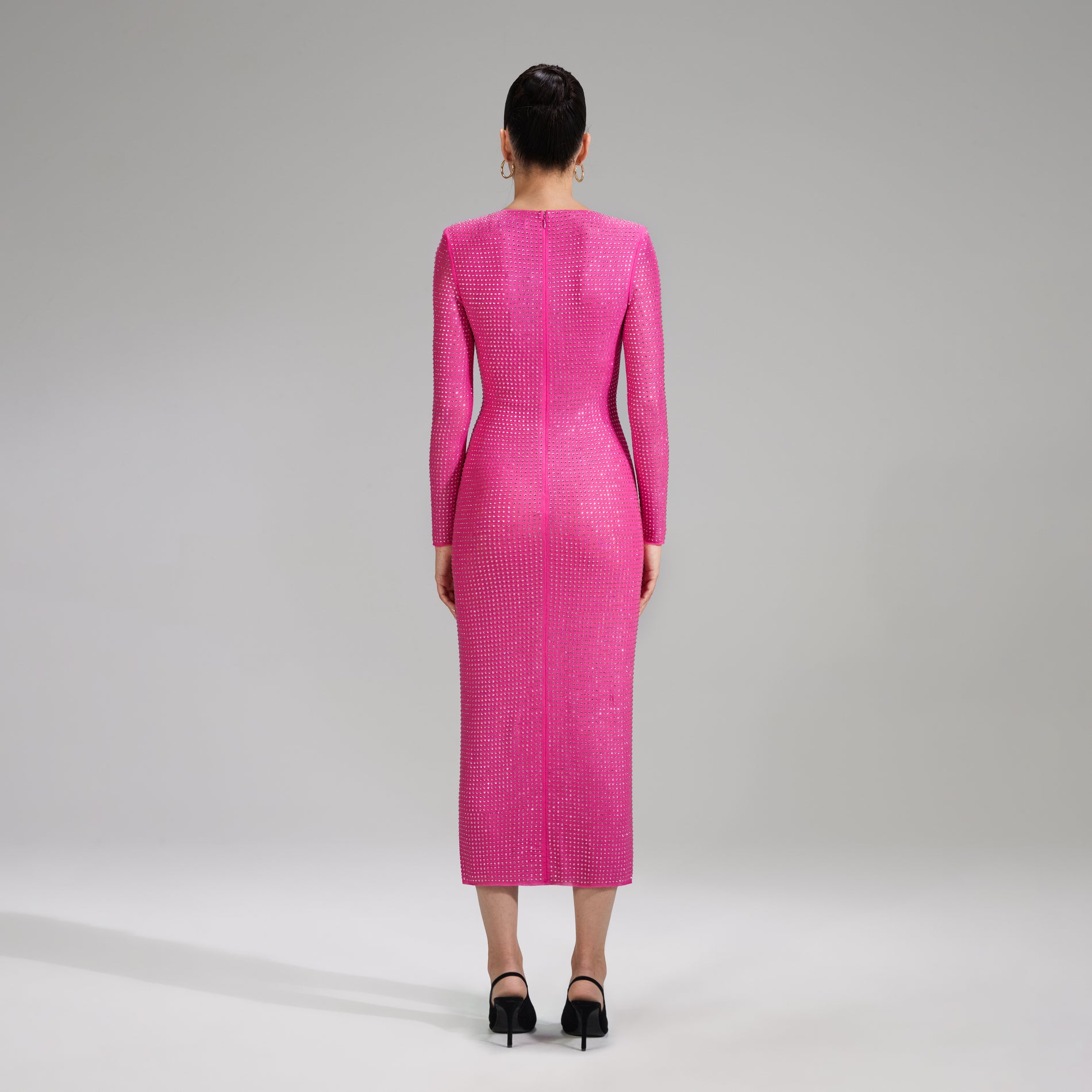 A woman wearing the Pink Rhinestone Mesh Midi Dress