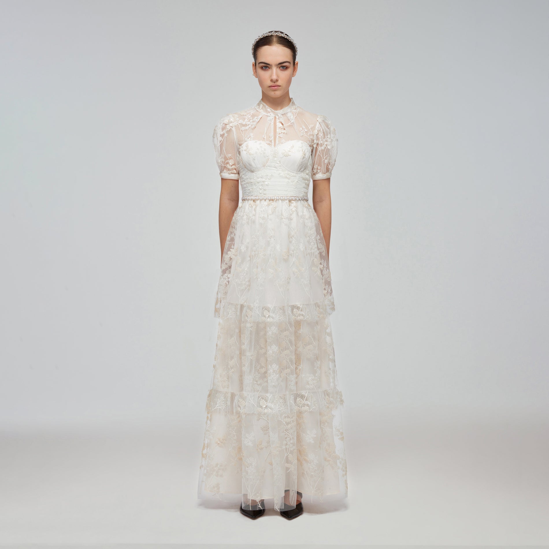 A woman wearing the Ivory Blossom Sequin Tiered Maxi Dress