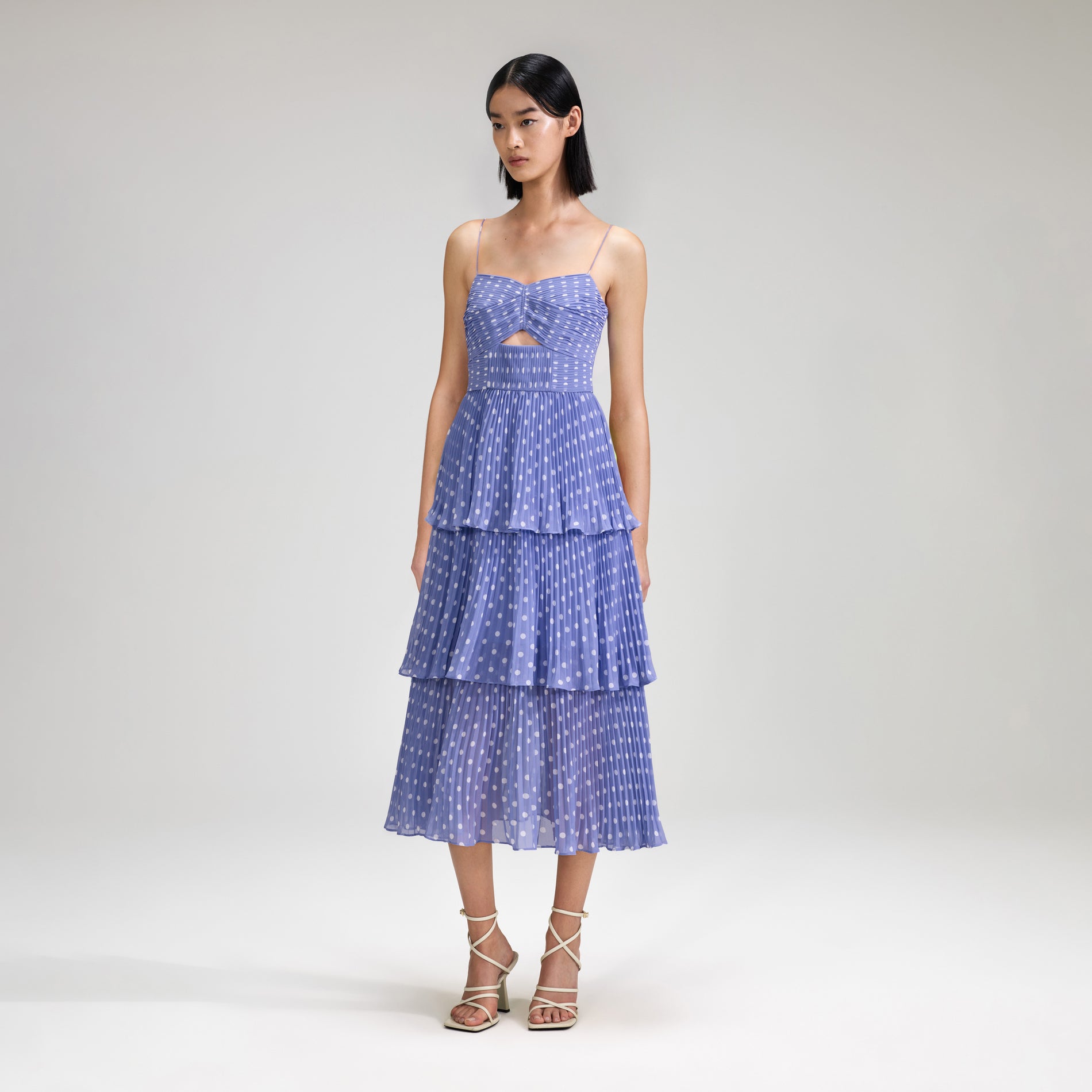 A woman wearing the Lilac Polka Dot Tiered Chiffon Midi Dress