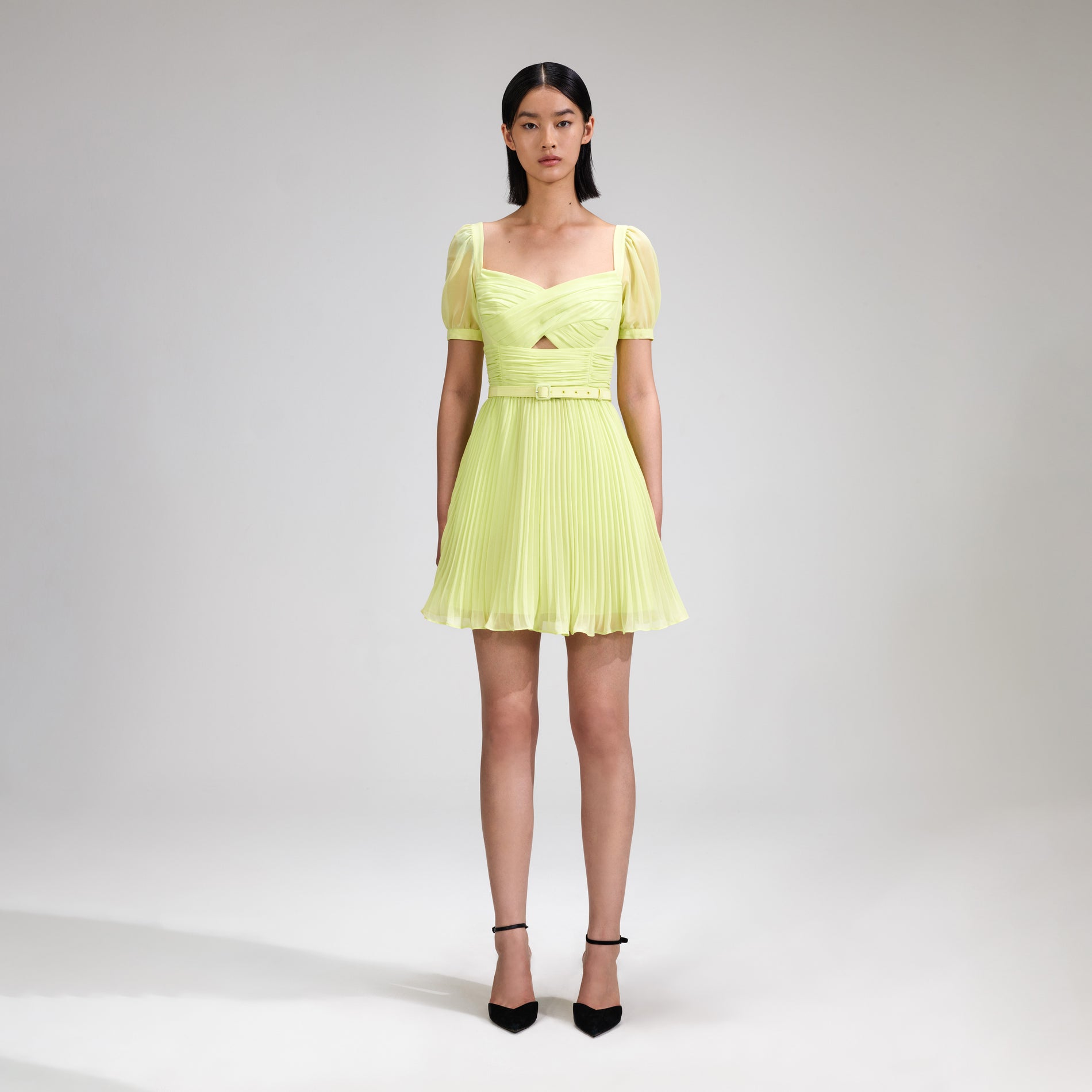 A woman wearing the Lime Chiffon Mini Dress
