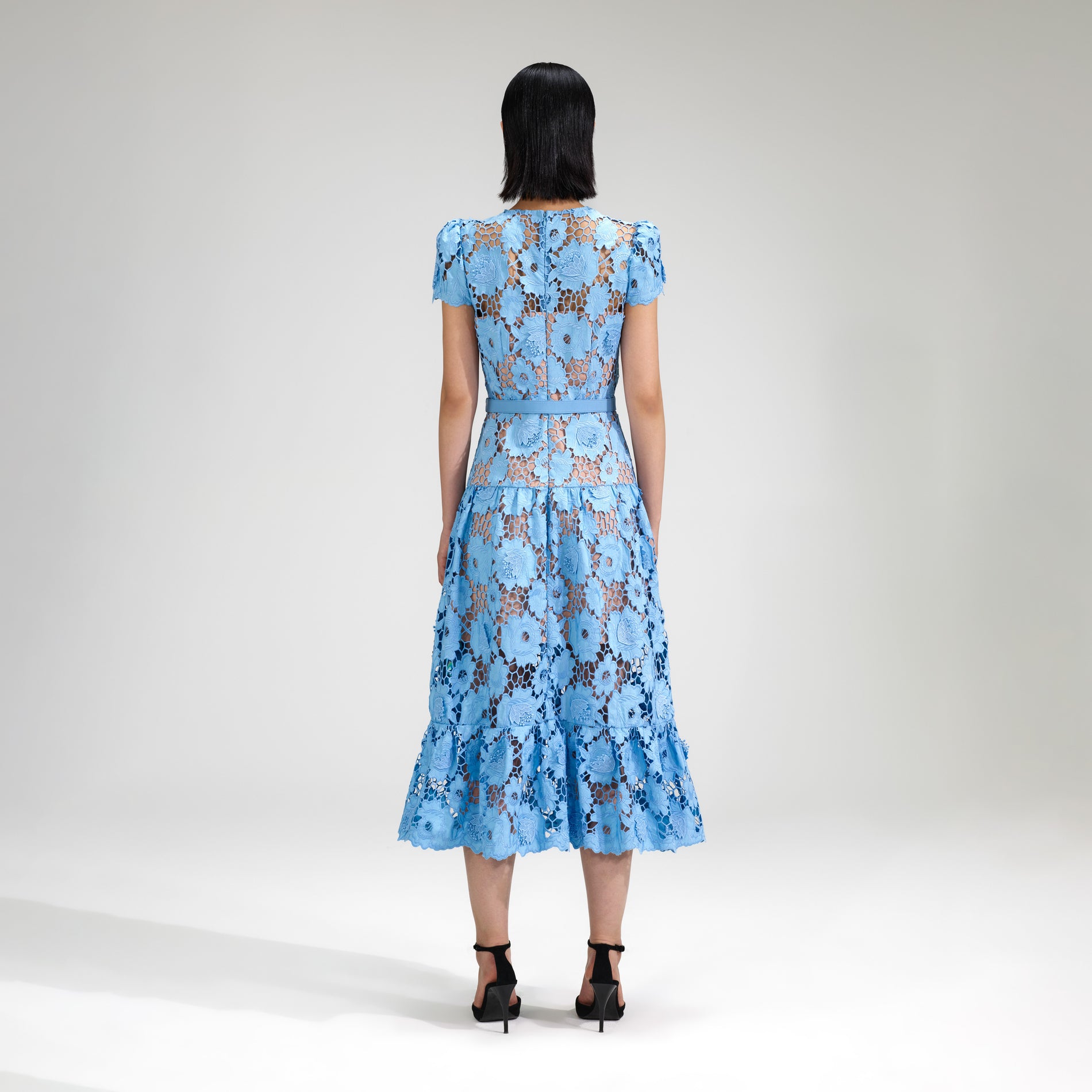 A woman wearing the Blue 3D Cotton Lace Midi Dress