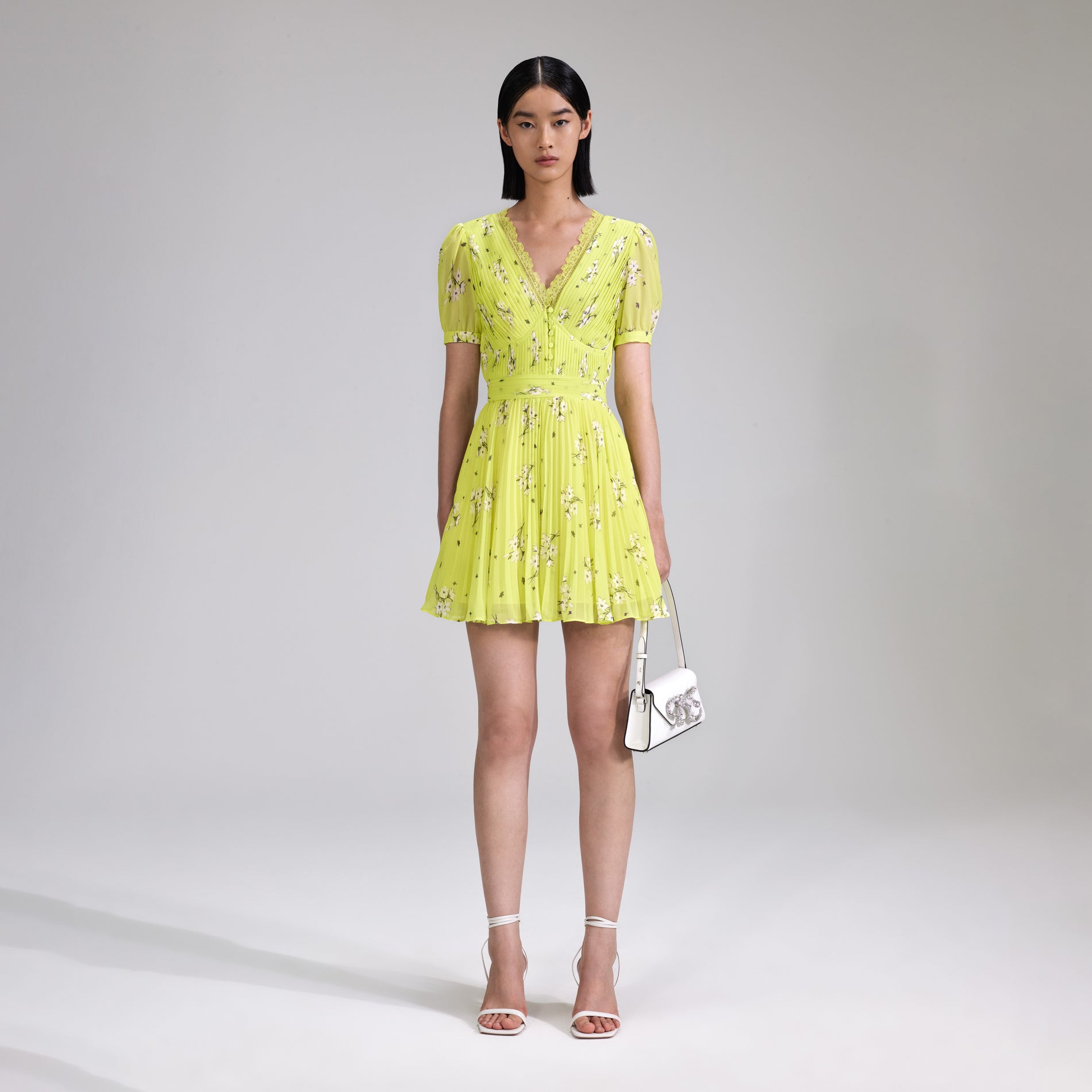 A woman wearing the Lime Floral Chiffon Mini Dress