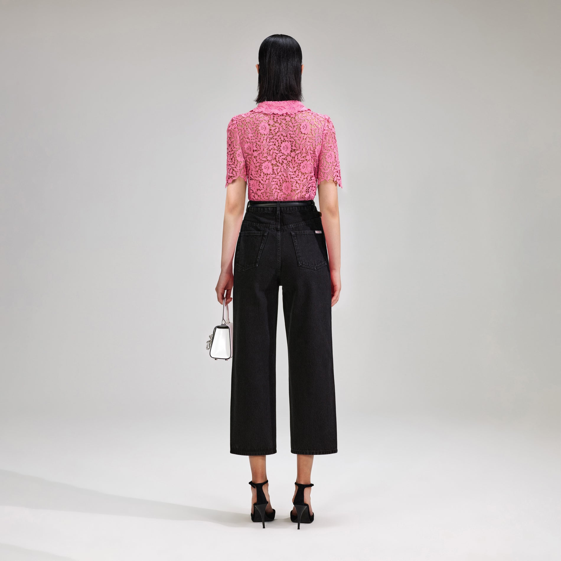 A woman wearing the Pink Rose Lace Top