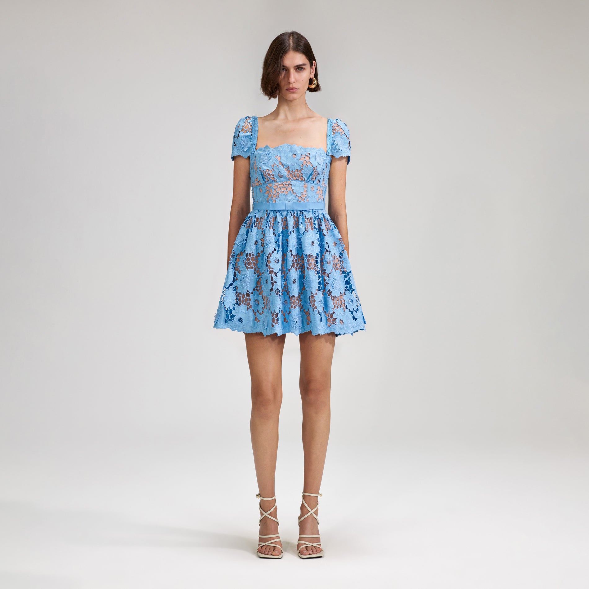 A woman wearing the Blue 3D Cotton Lace Mini Dress