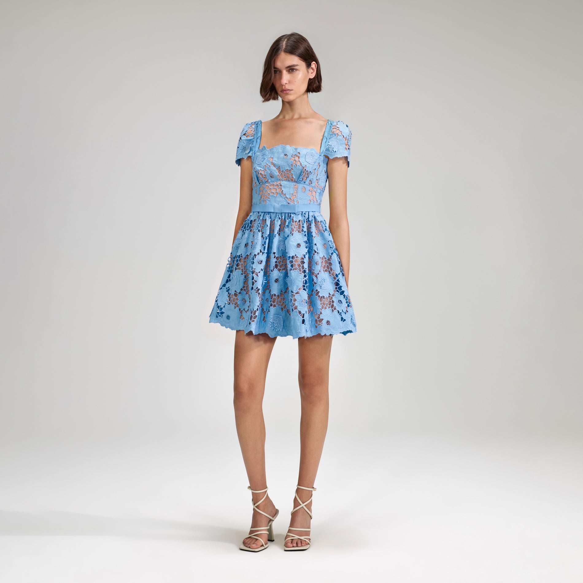 A woman wearing the Blue 3D Cotton Lace Mini Dress